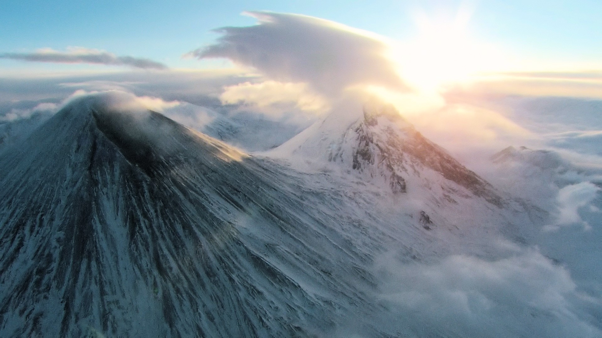 Snow-covered volcanoes at sunrise with clouds HD Wallpaper