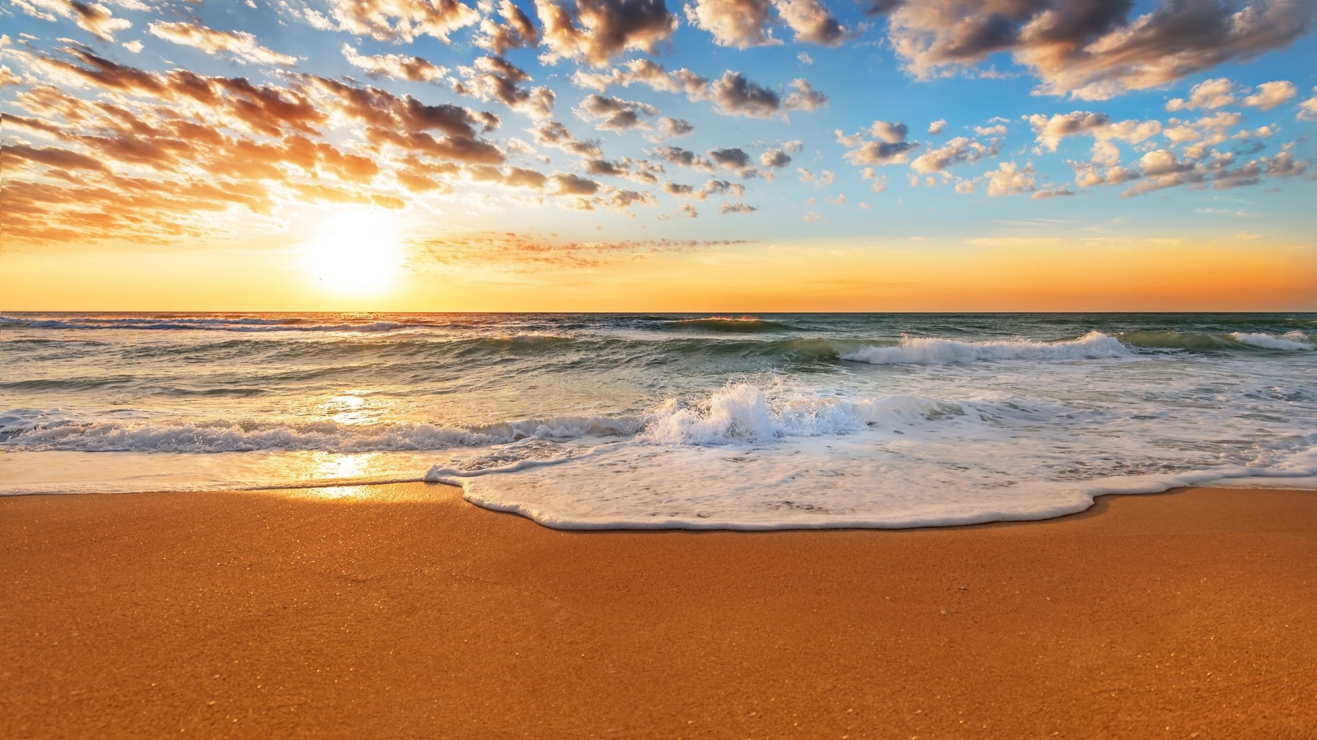 Sunset over the ocean with waves on the beach HD Wallpaper