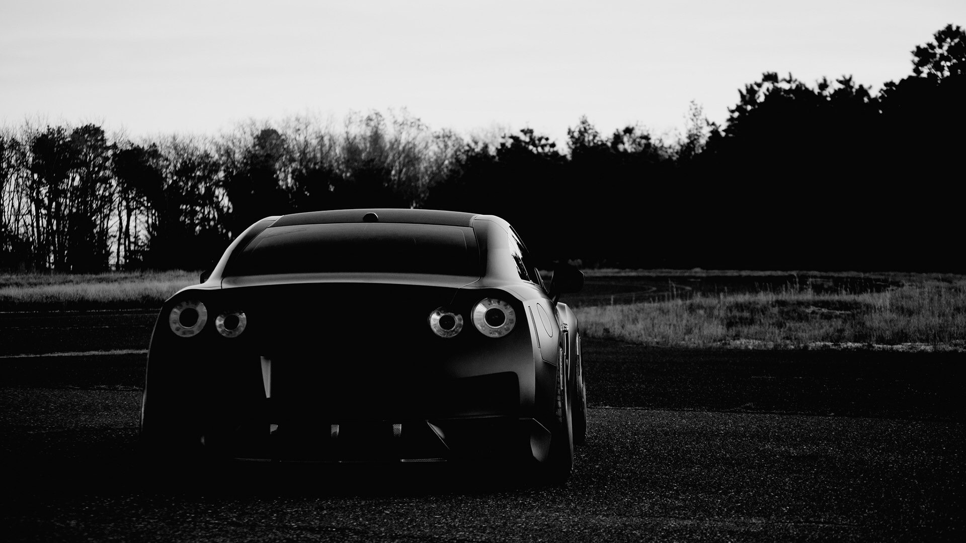 Black Nissan GT-R parked on asphalt HD Wallpaper