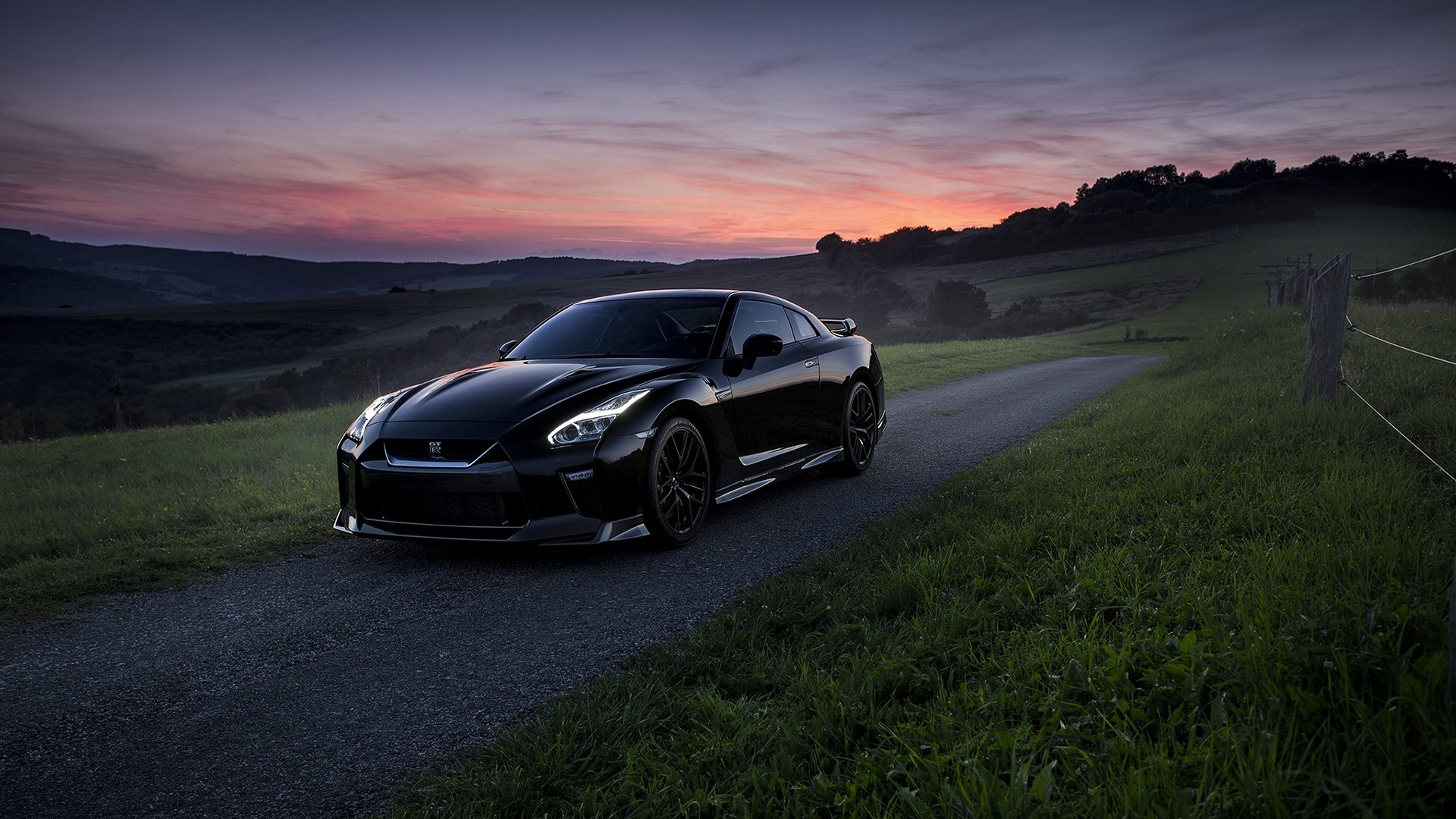 Black Nissan GT-R on a country road at sunset HD Wallpaper