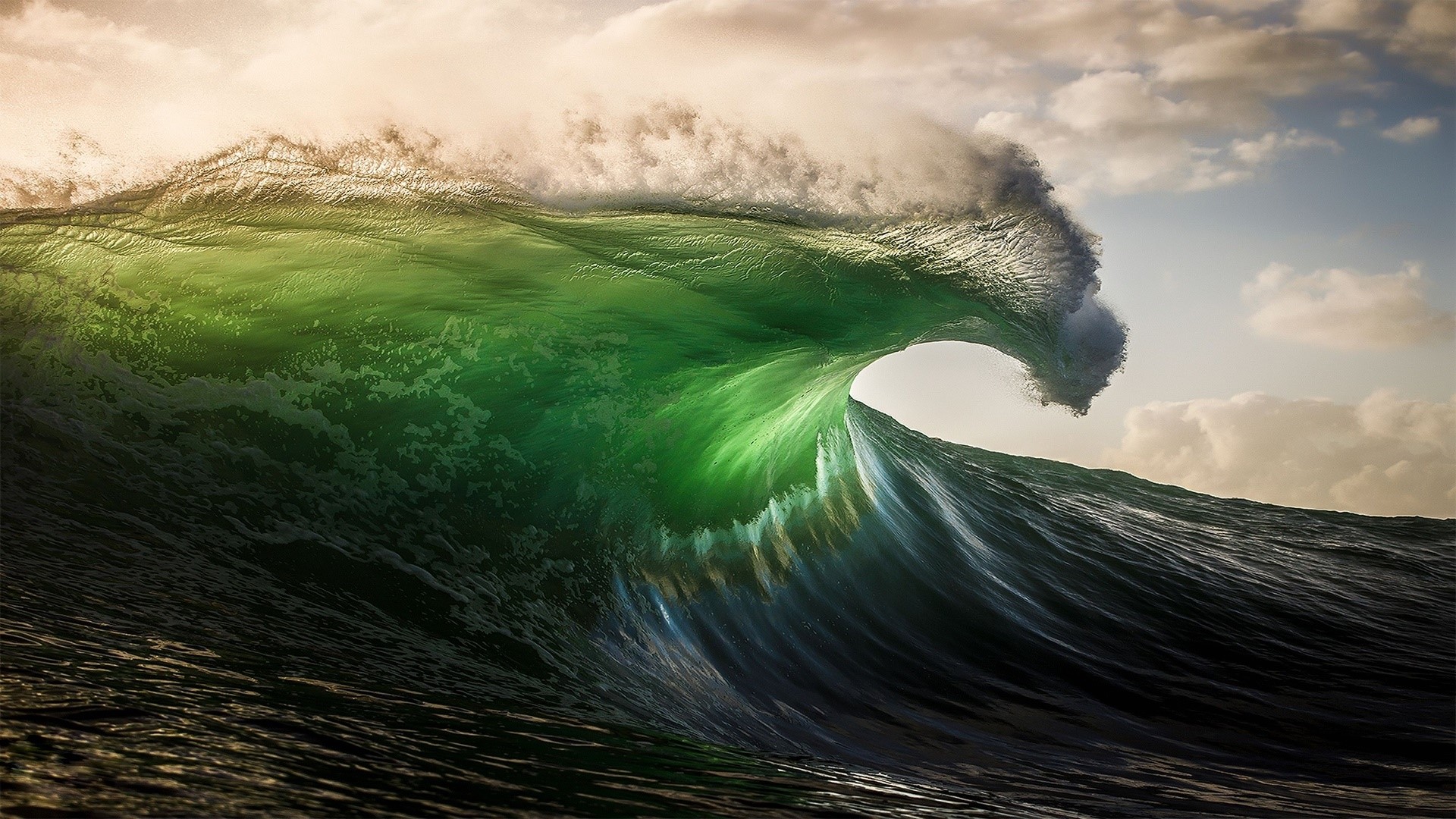 Green wave cresting with clouds in the background HD Wallpaper