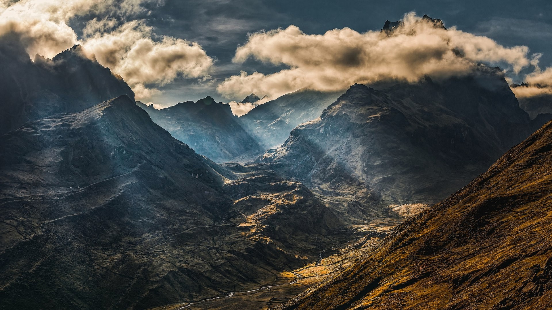 Mountain valley with dramatic clouds and sunbeams HD Wallpaper