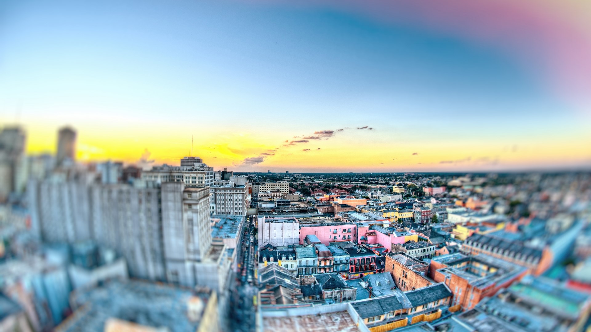 Aerial view of a city skyline at sunset HD Wallpaper