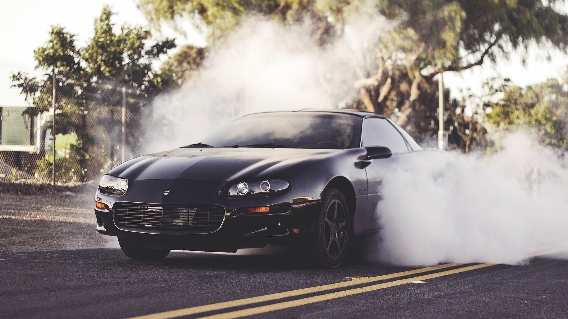 Black Chevrolet Camaro Z28 doing a burnout HD Wallpaper