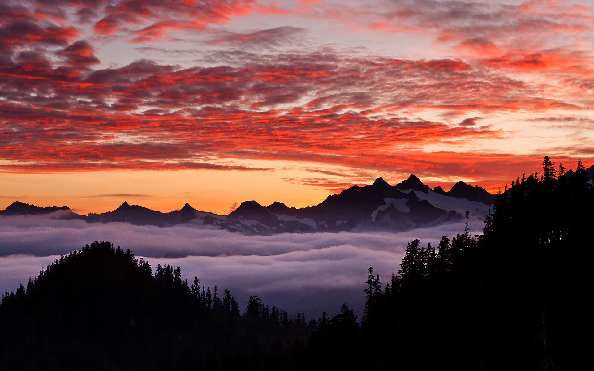 Mountain range at sunset with clouds and trees HD Wallpaper