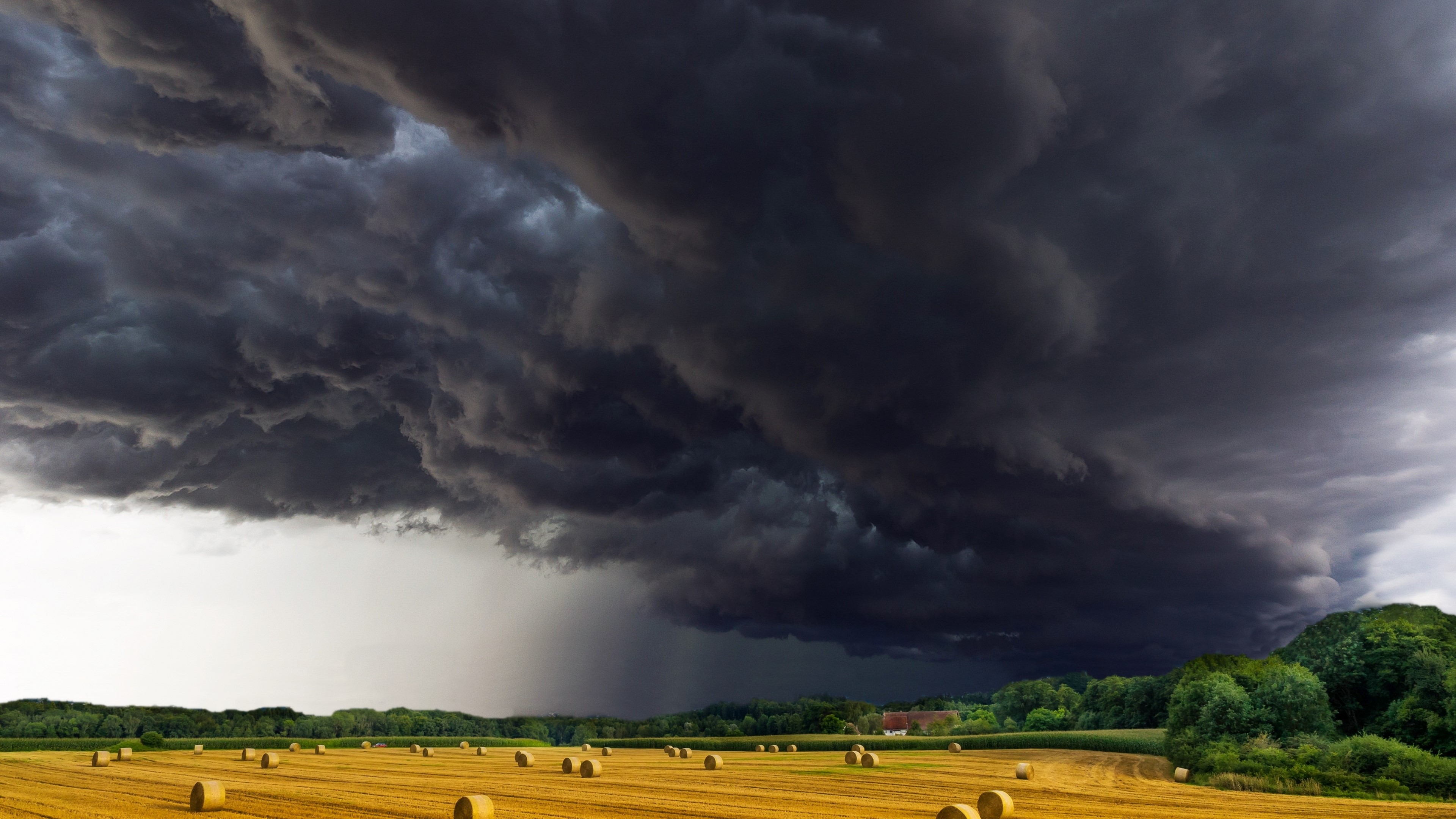 Stormy Sky Over Hay Bales HD Wallpaper