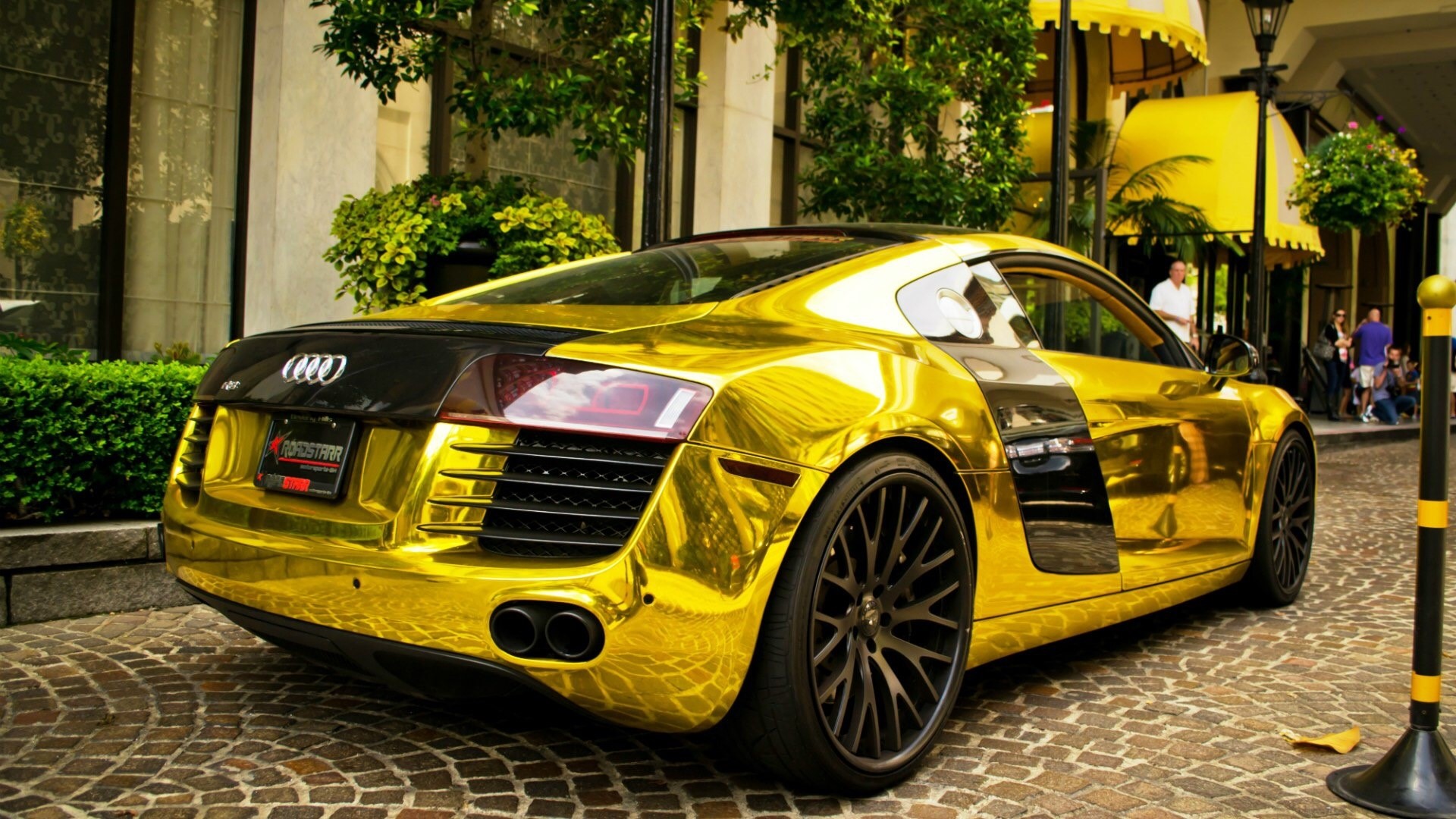 Gold Audi R8 parked on cobblestone street HD Wallpaper