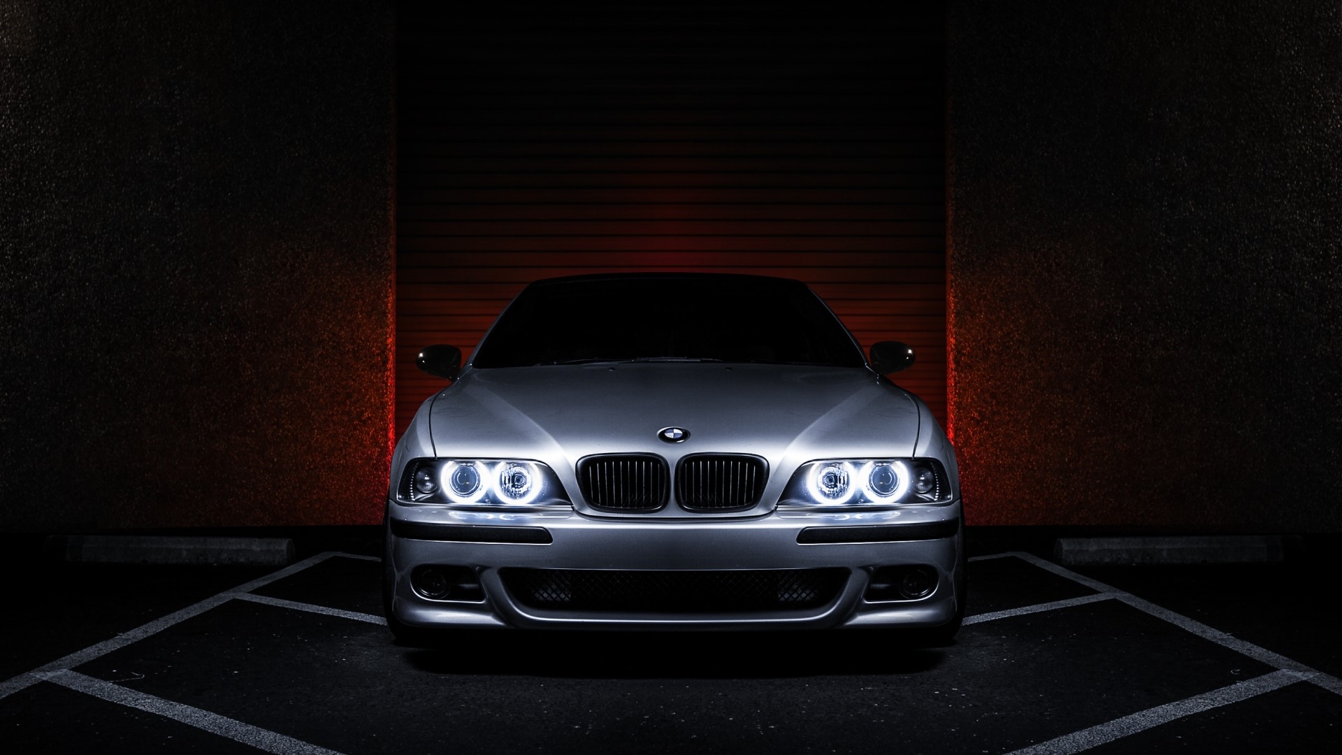 Silver BMW parked in a dark garage HD Wallpaper