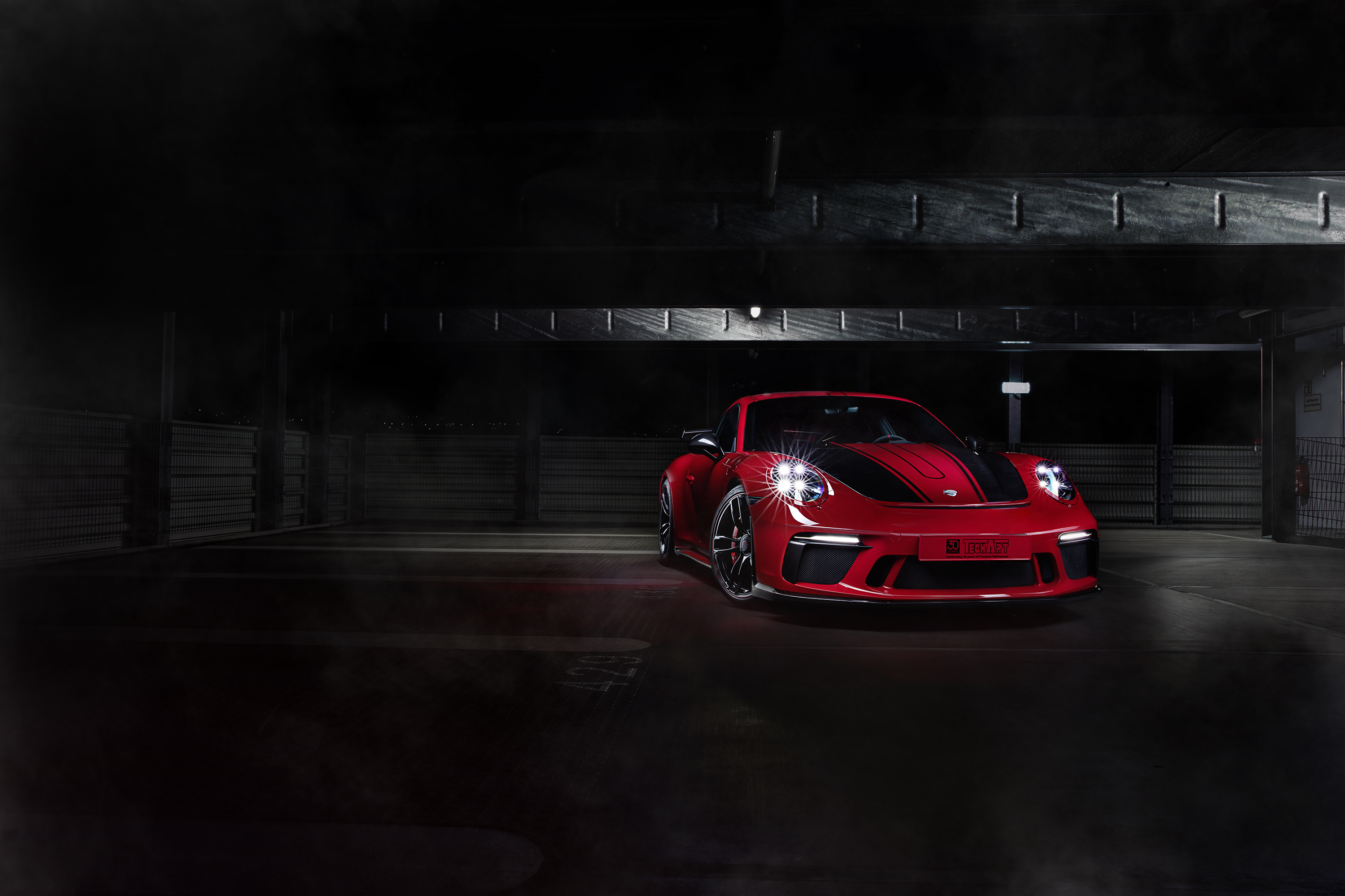 Red TechArt Porsche 911 GT3 in a dark garage HD Wallpaper