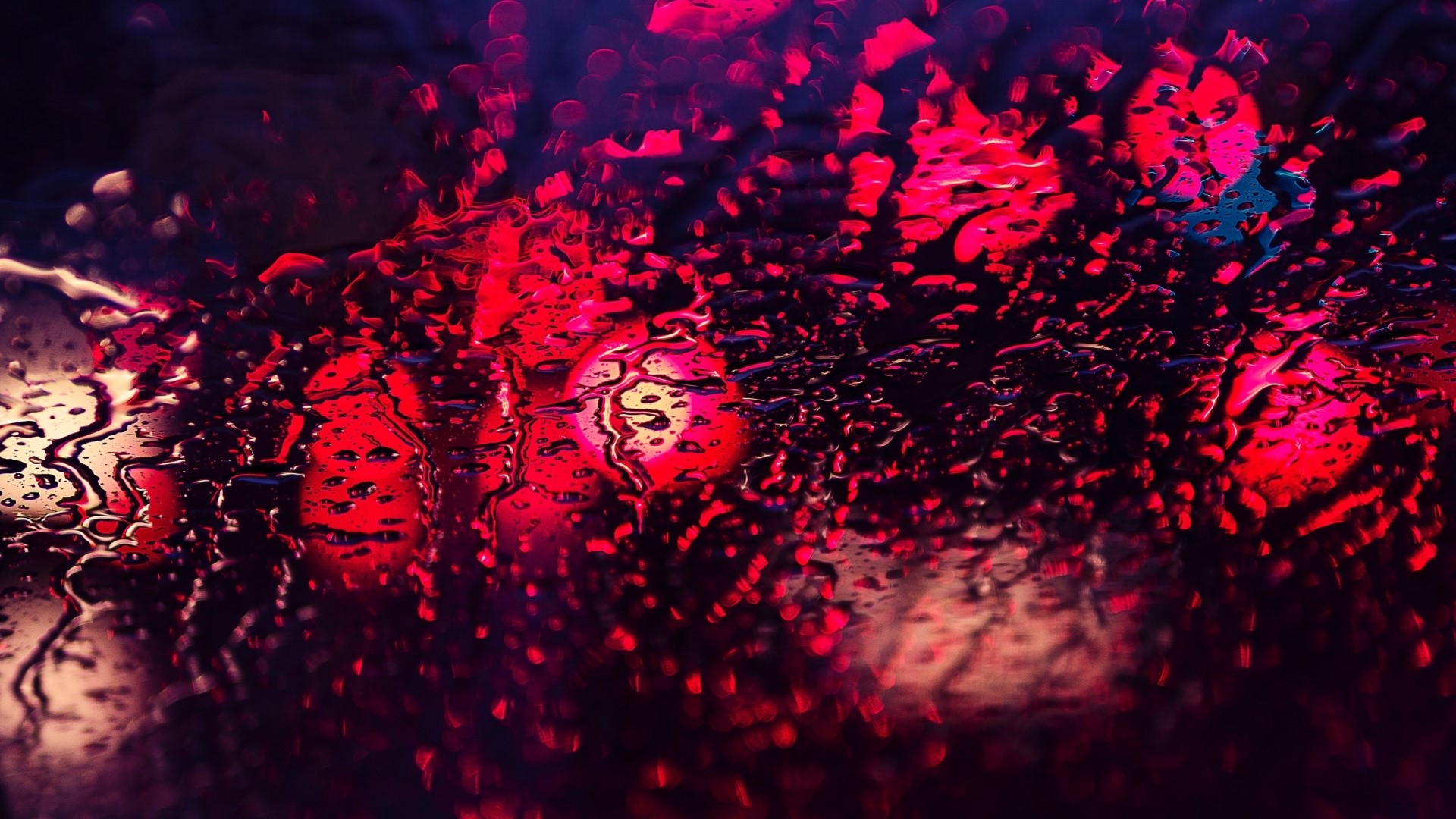 Water drops on glass with red lights HD Wallpaper
