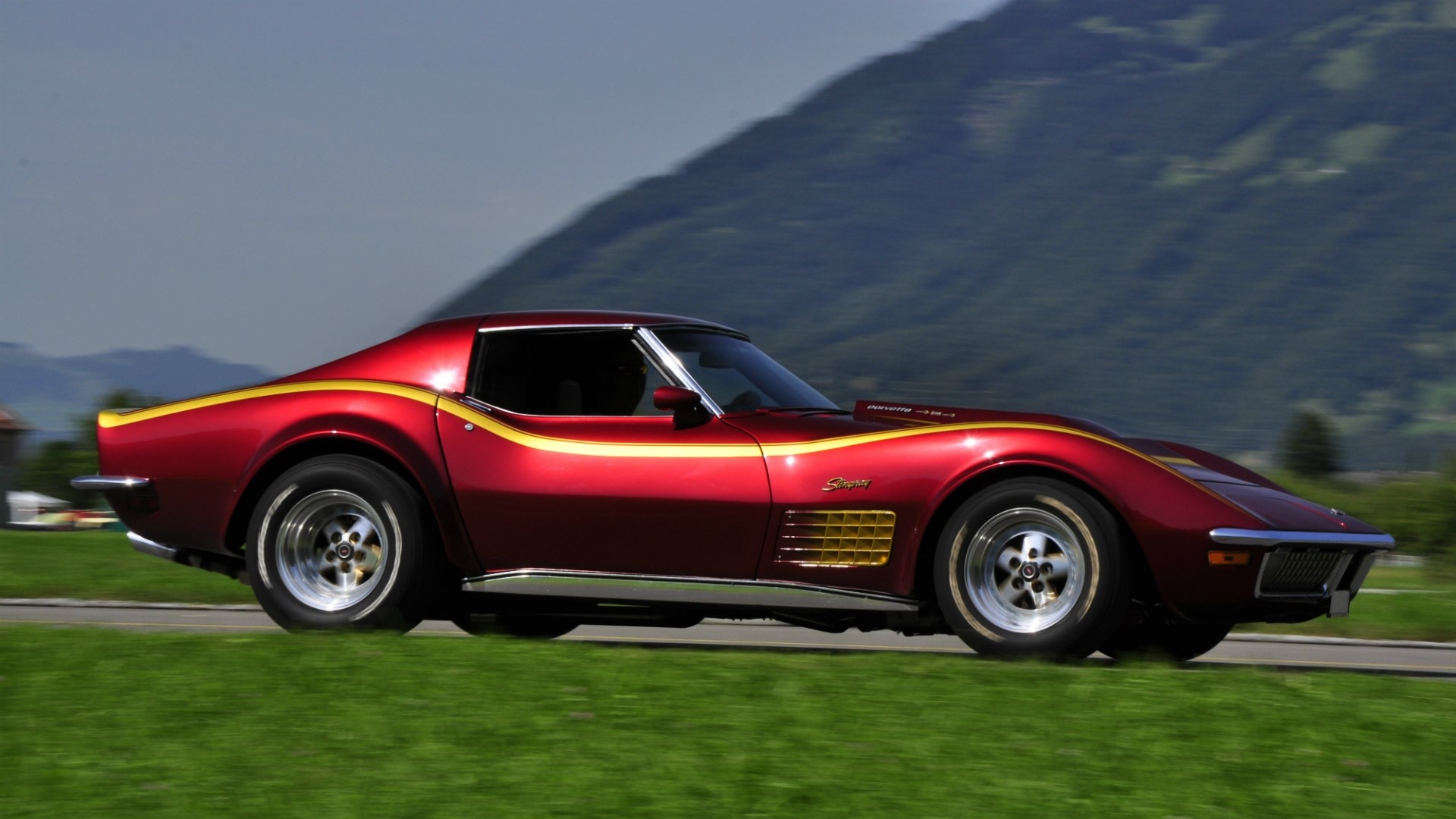 1970 Chevrolet Corvette Stingray driving on a road HD Wallpaper