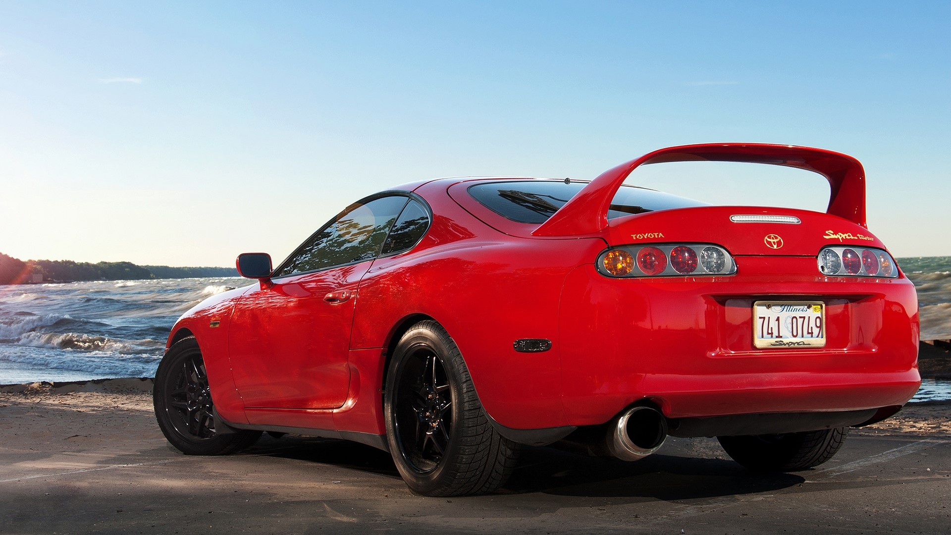 Red Toyota Supra by the water HD Wallpaper