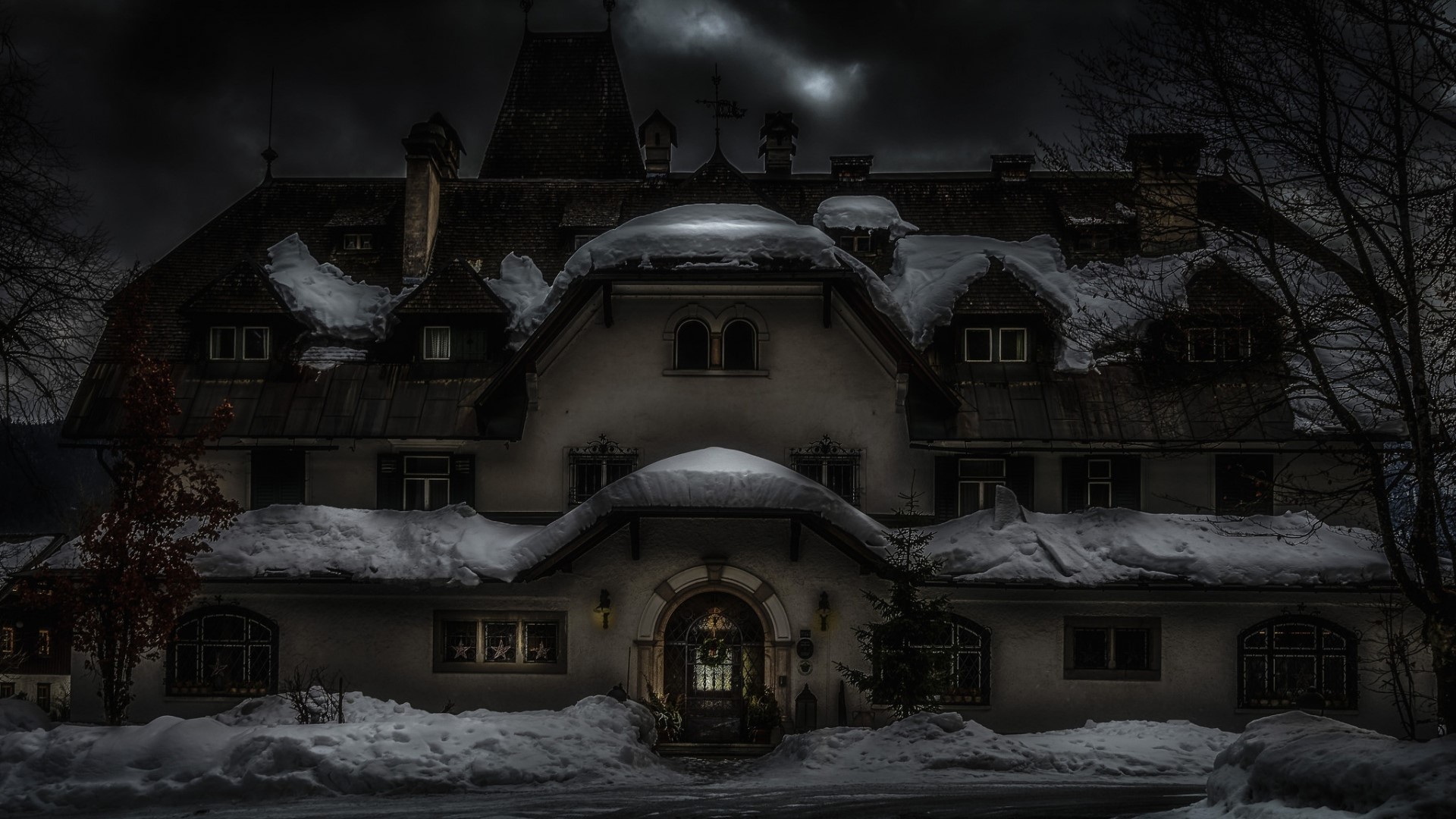 Snow-covered mansion at night HD Wallpaper
