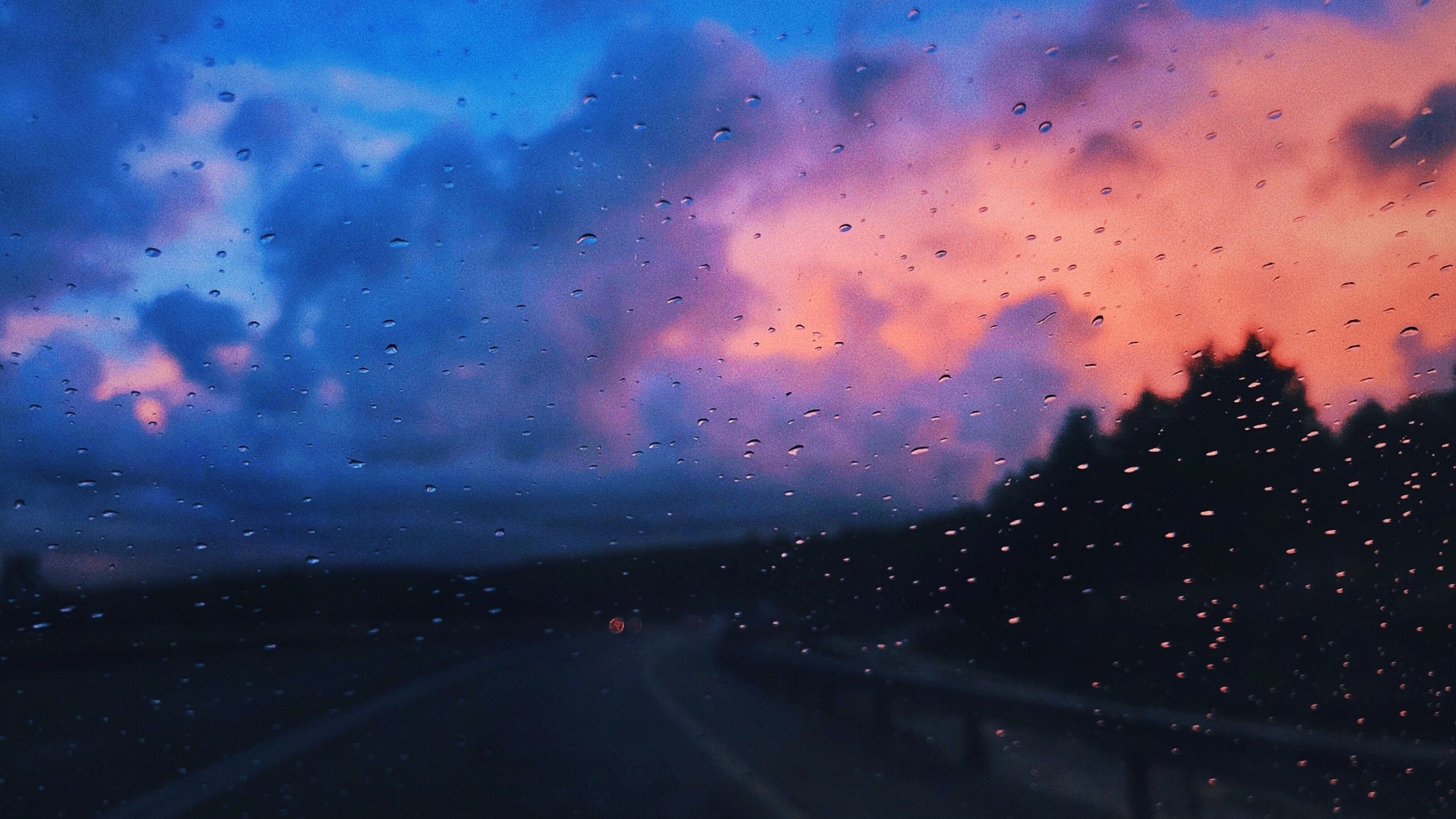 Sunset clouds seen through a rainy window HD Wallpaper