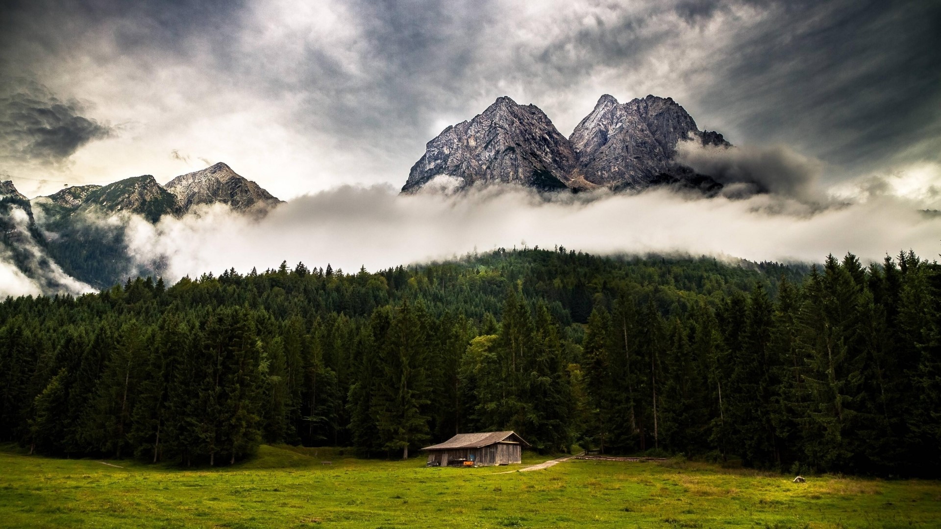 Mountains with clouds and a cabin HD Wallpaper