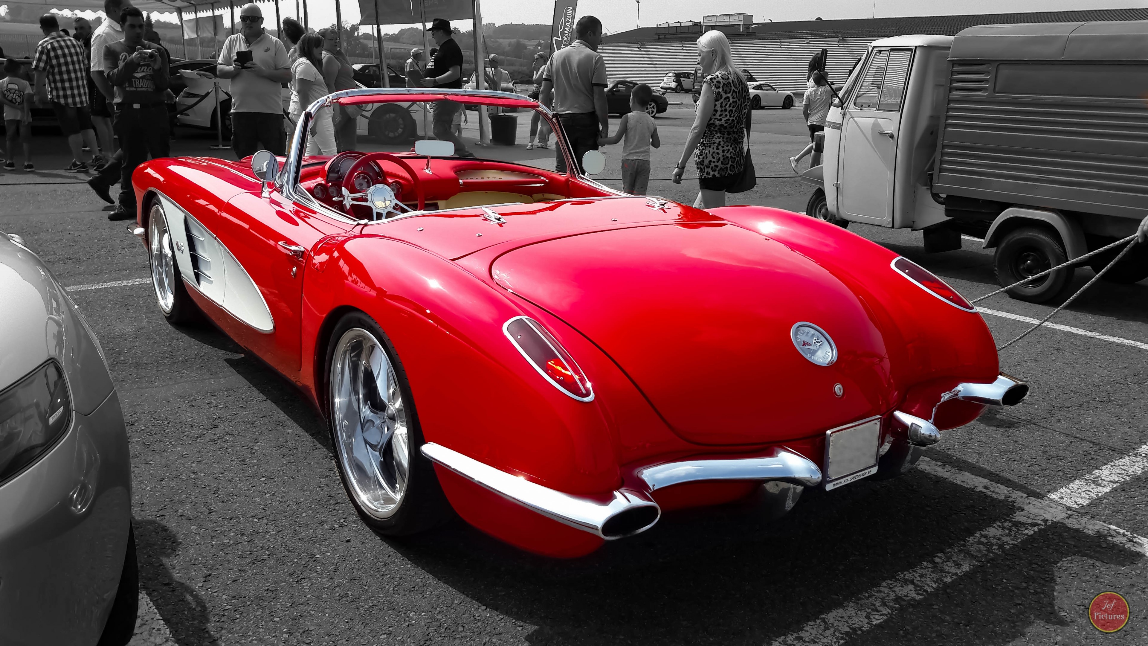 Red classic convertible car at an outdoor event HD Wallpaper