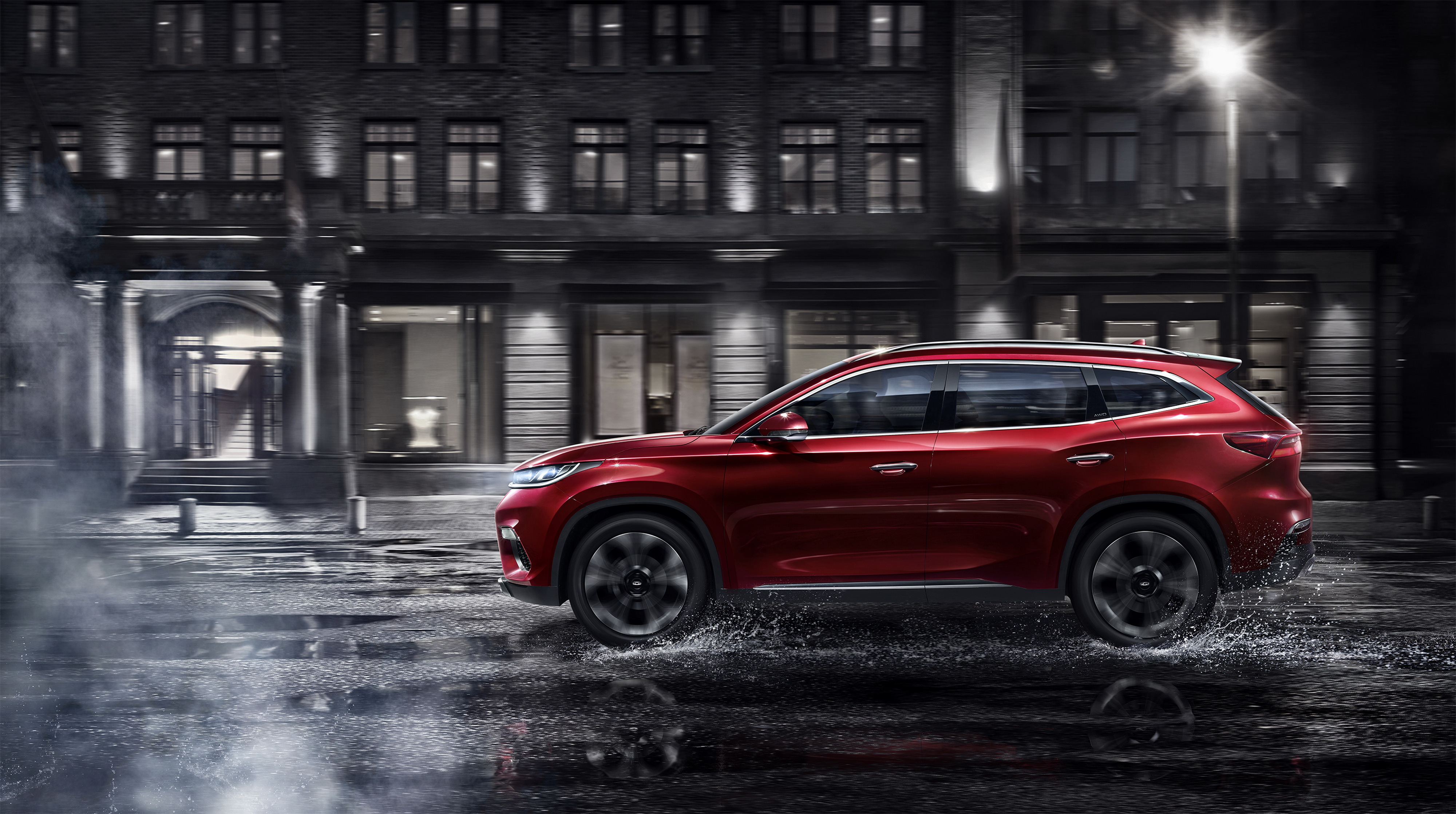 Chery Exeed TX driving in city at night HD Wallpaper