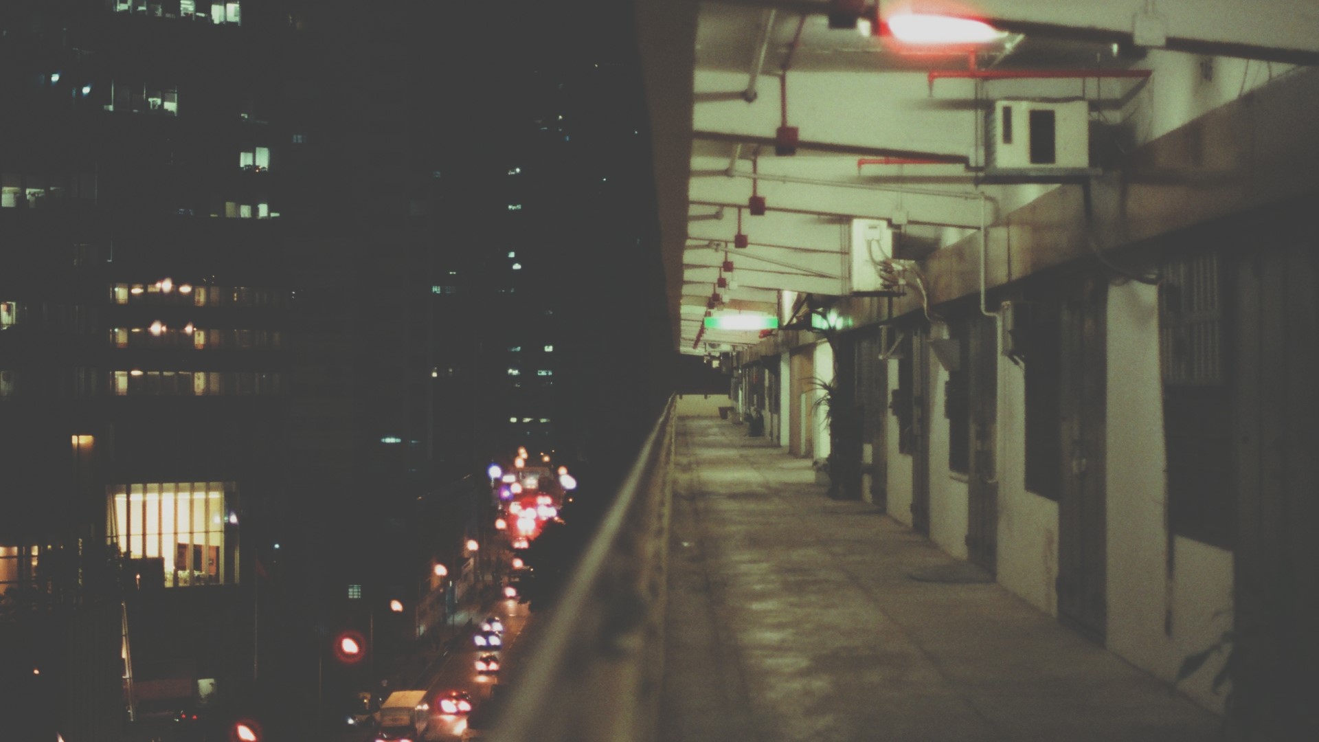 Night view of city buildings and a balcony HD Wallpaper