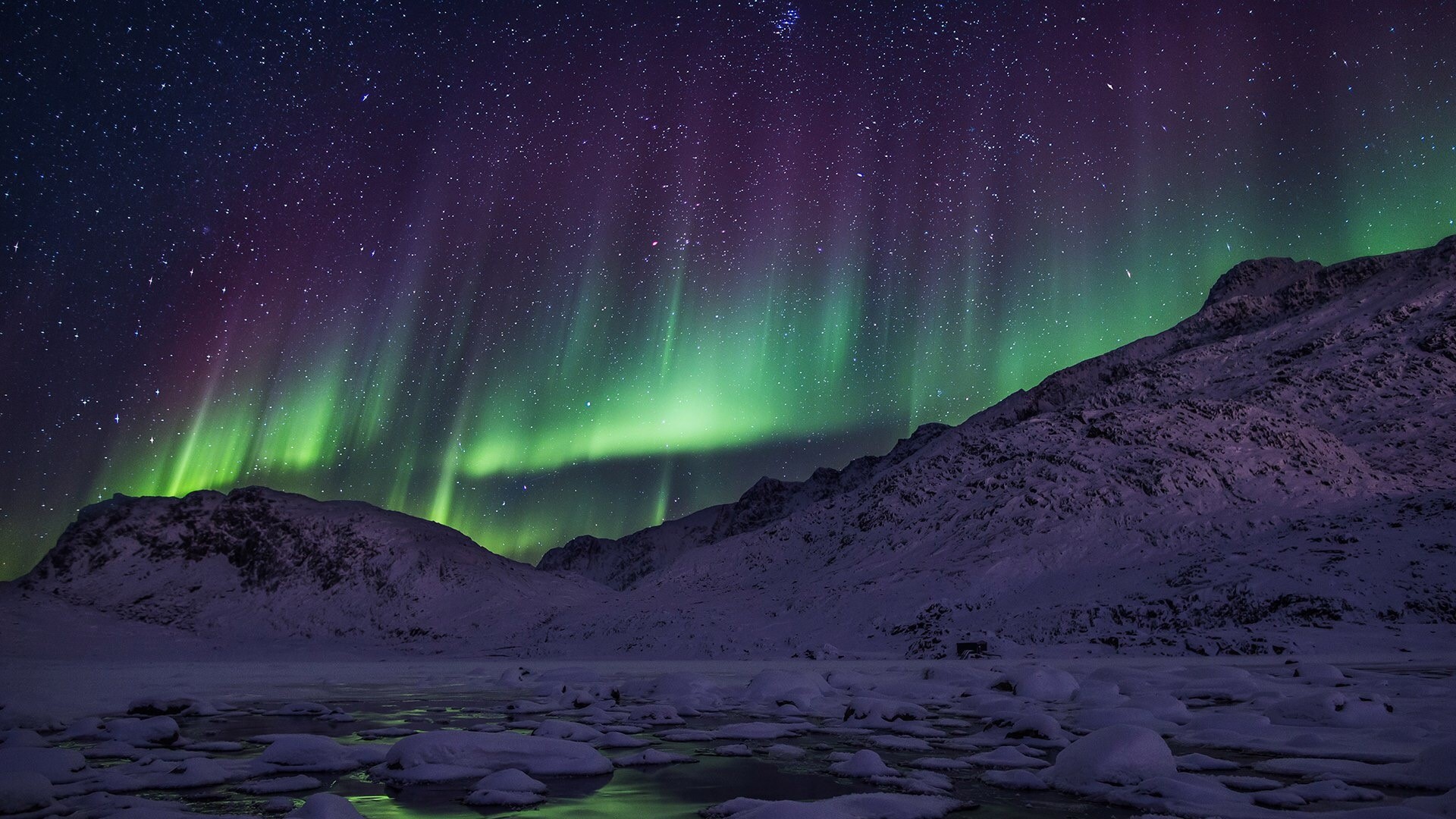 Northern lights over snowy mountains and frozen lake HD Wallpaper