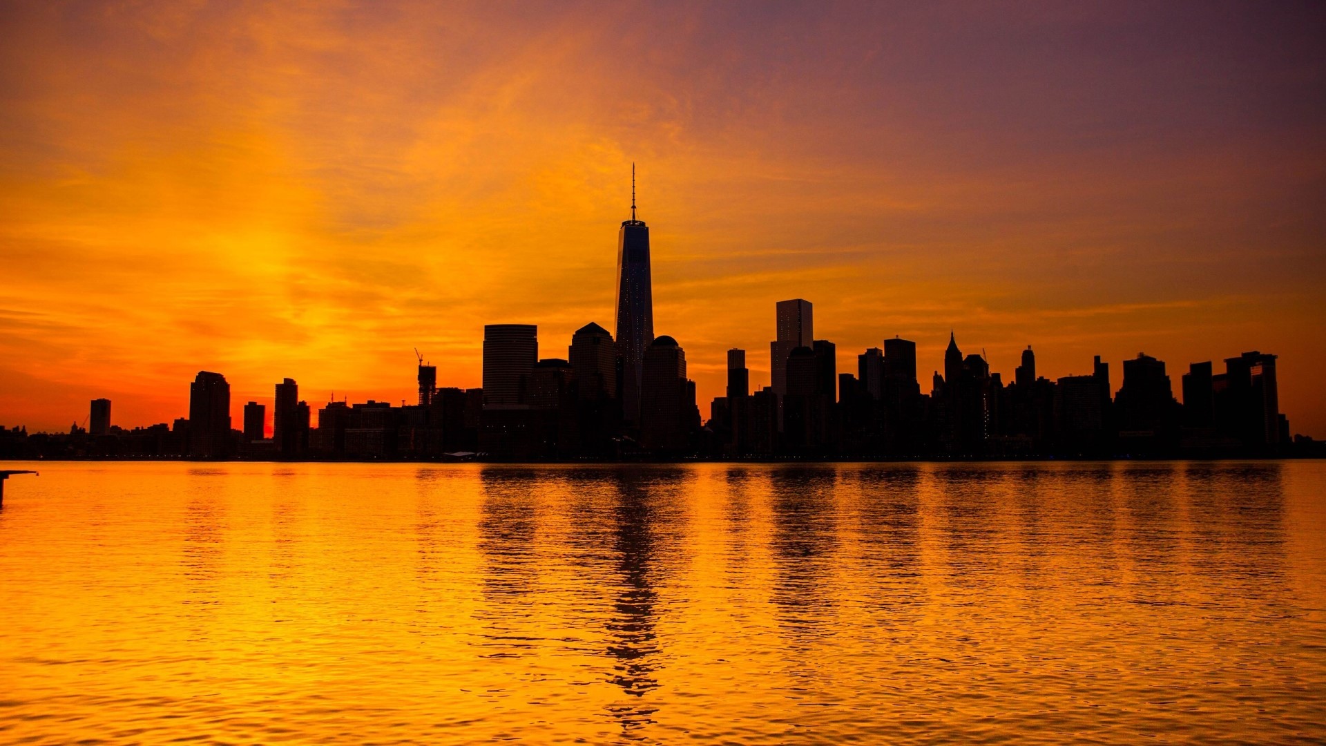 New York City skyline at sunset over water HD Wallpaper