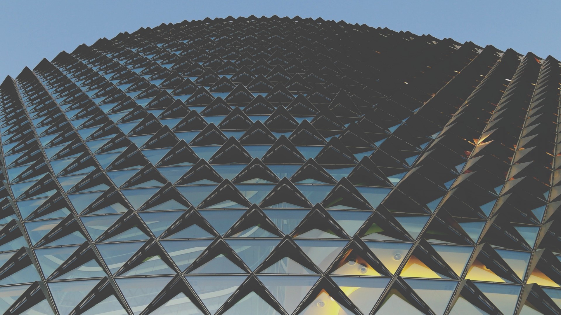 Geometric building facade with triangular windows HD Wallpaper