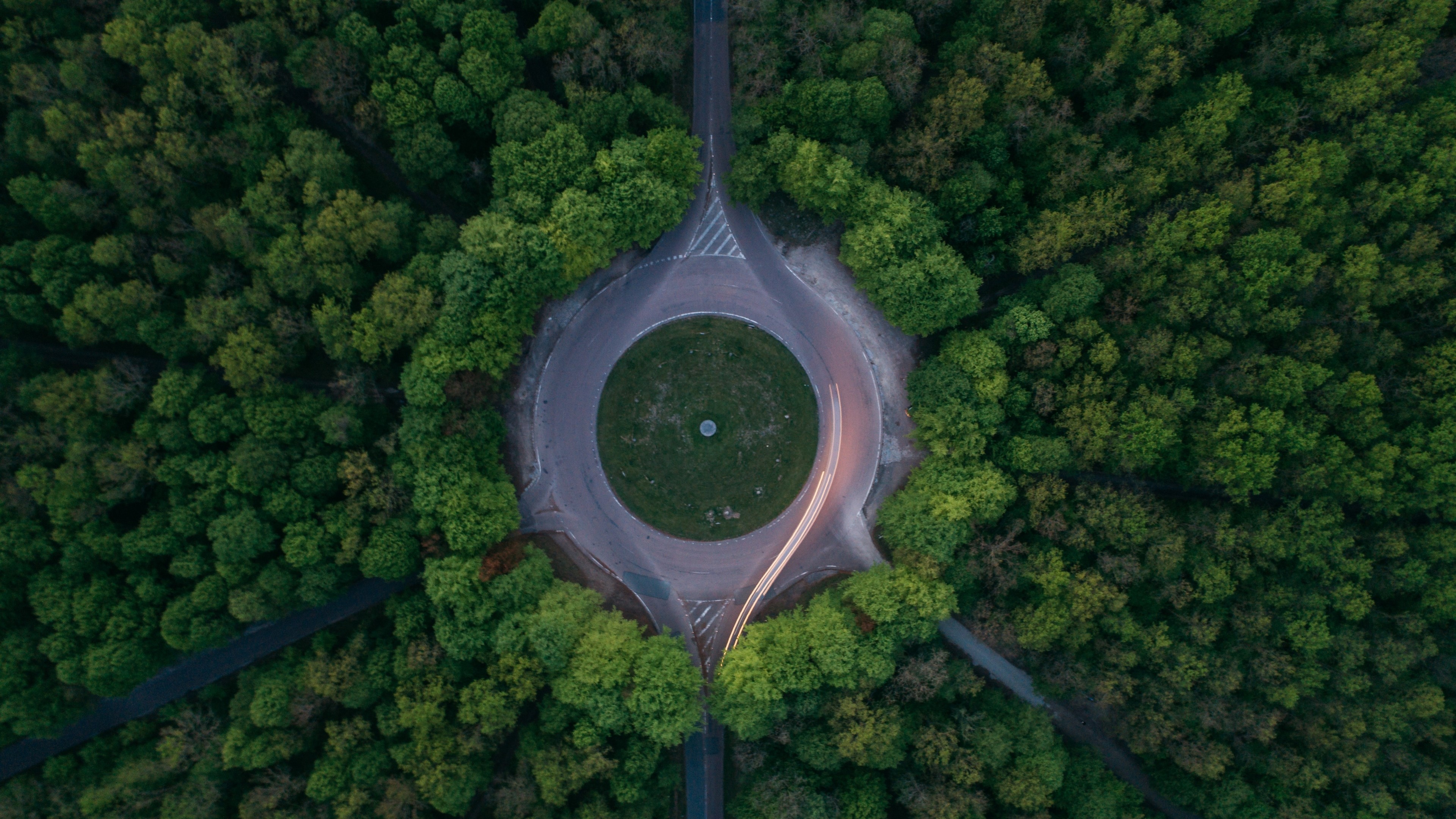 Aerial view of a roundabout in a forest HD Wallpaper