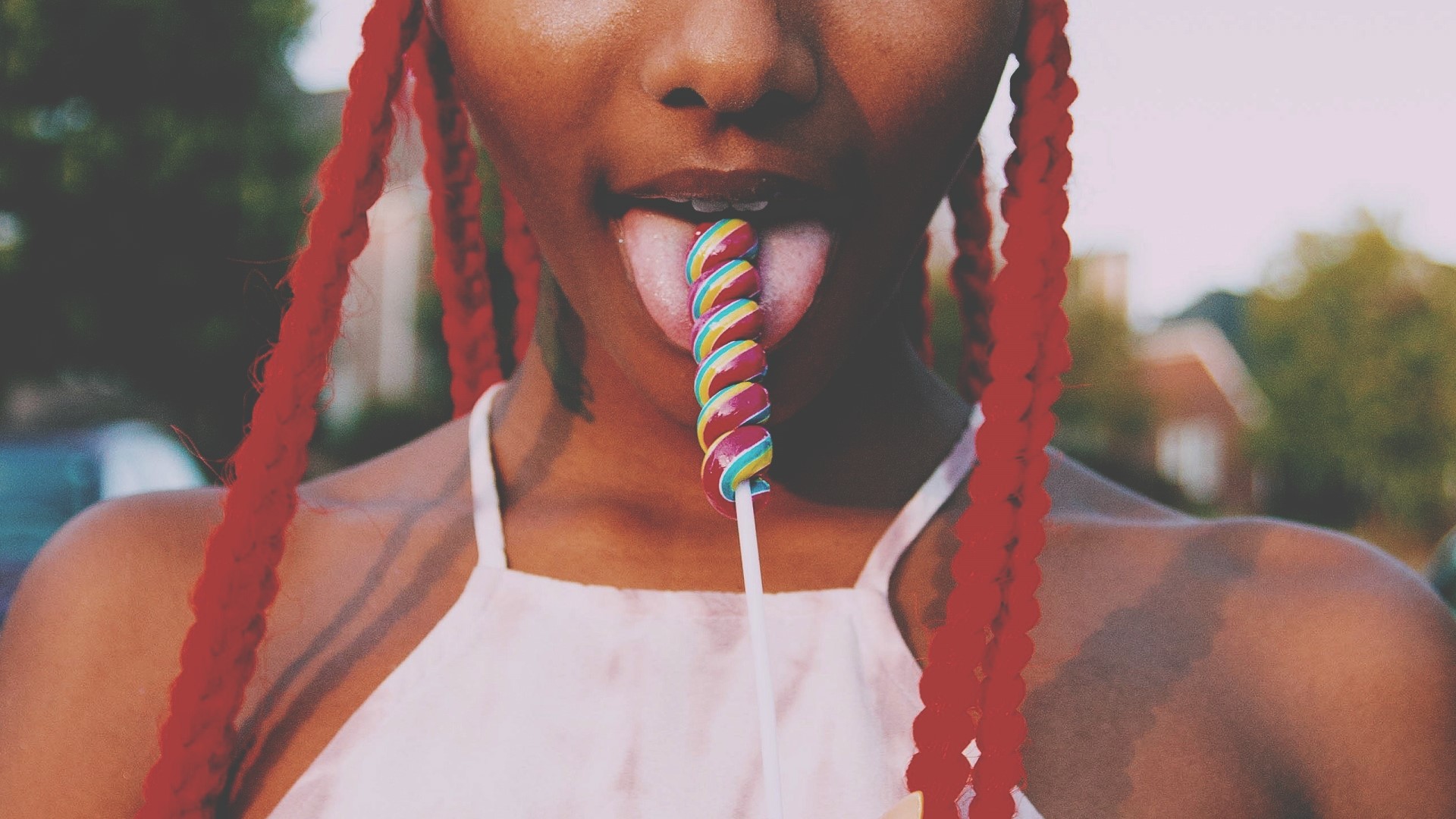 Woman with red braids licking a lollipop HD Wallpaper