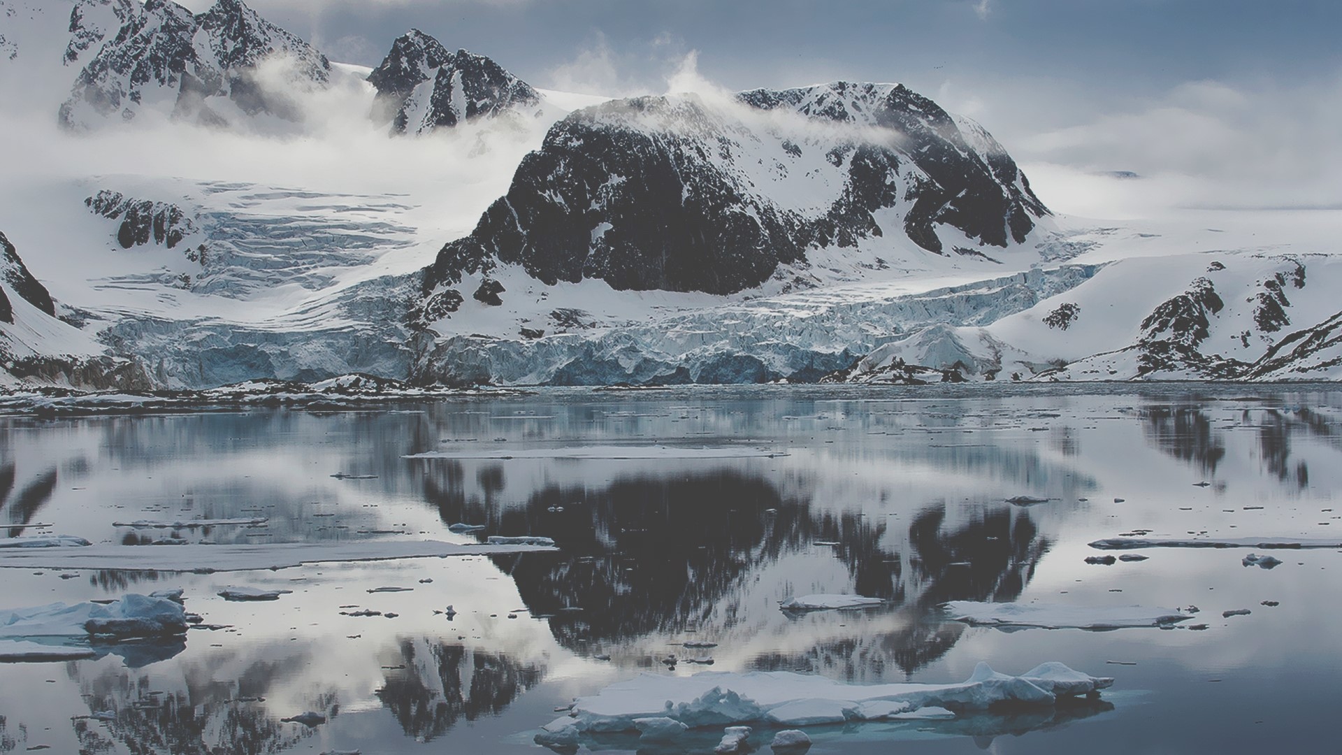 Snowy mountains and glacier reflected in calm water HD Wallpaper