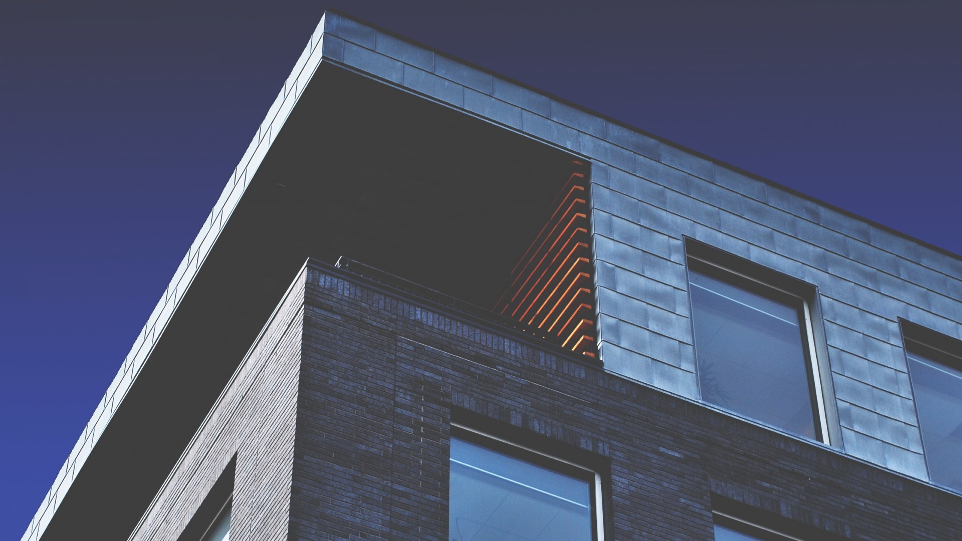 Modern Building with Dark Brick and Metal Facade HD Wallpaper