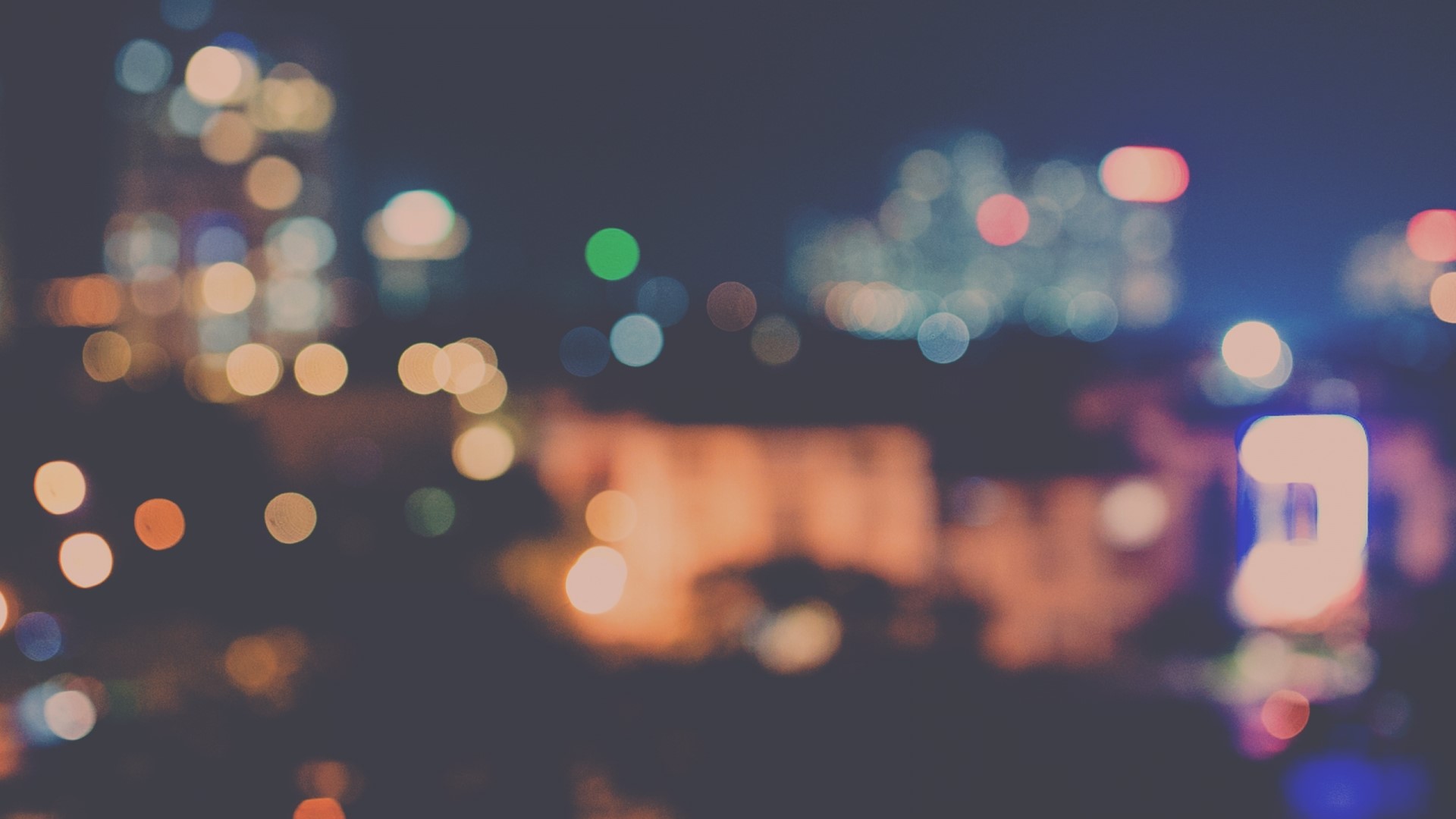 Bokeh lights of a city at night HD Wallpaper