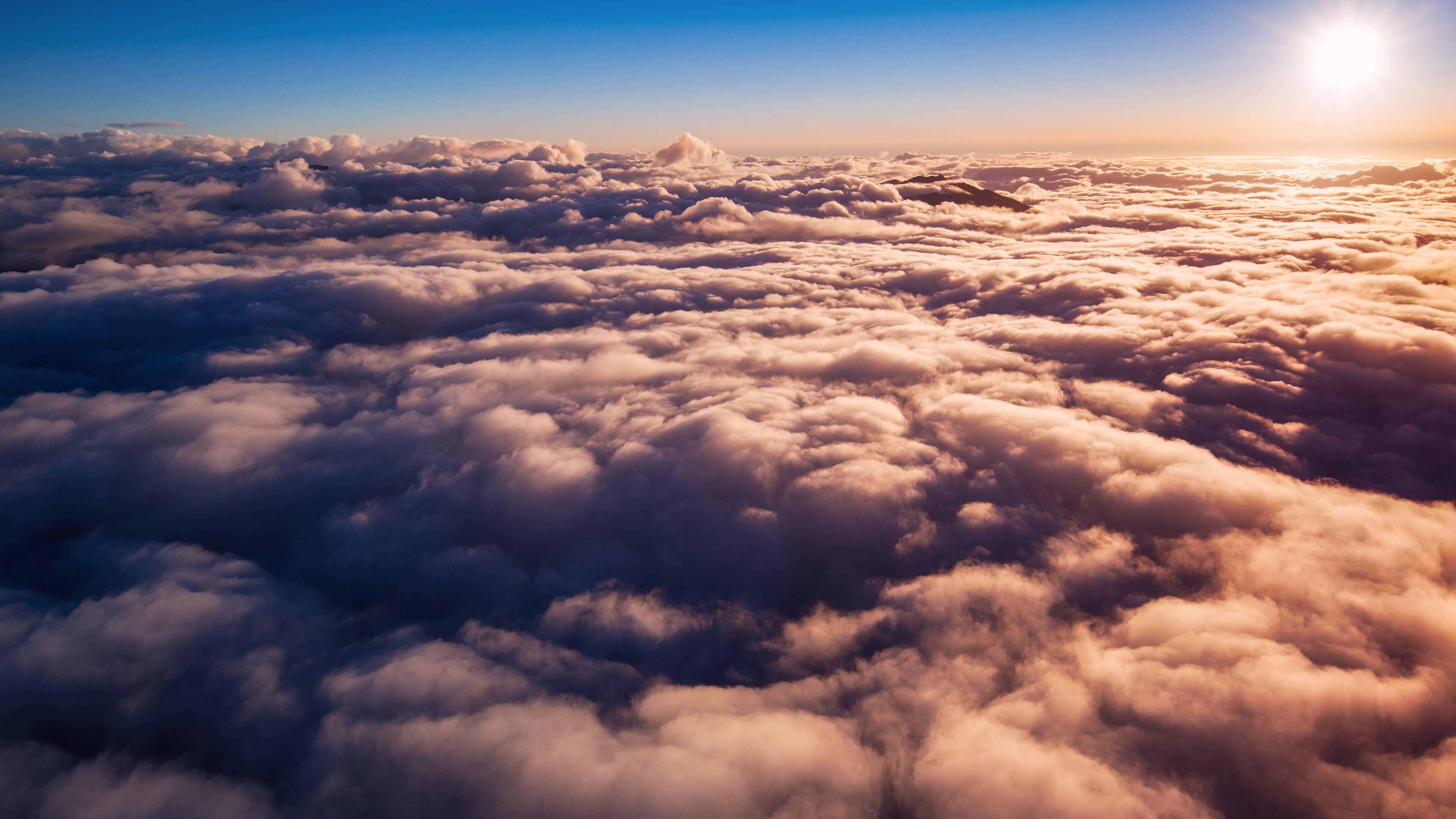 Sunrise over a sea of clouds HD Wallpaper