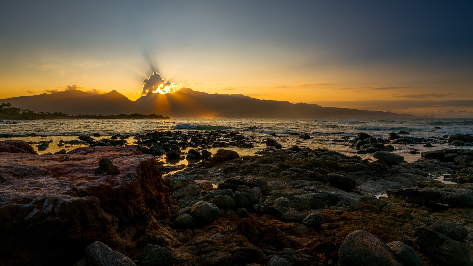 Sunset over mountains and rocky beach HD Wallpaper