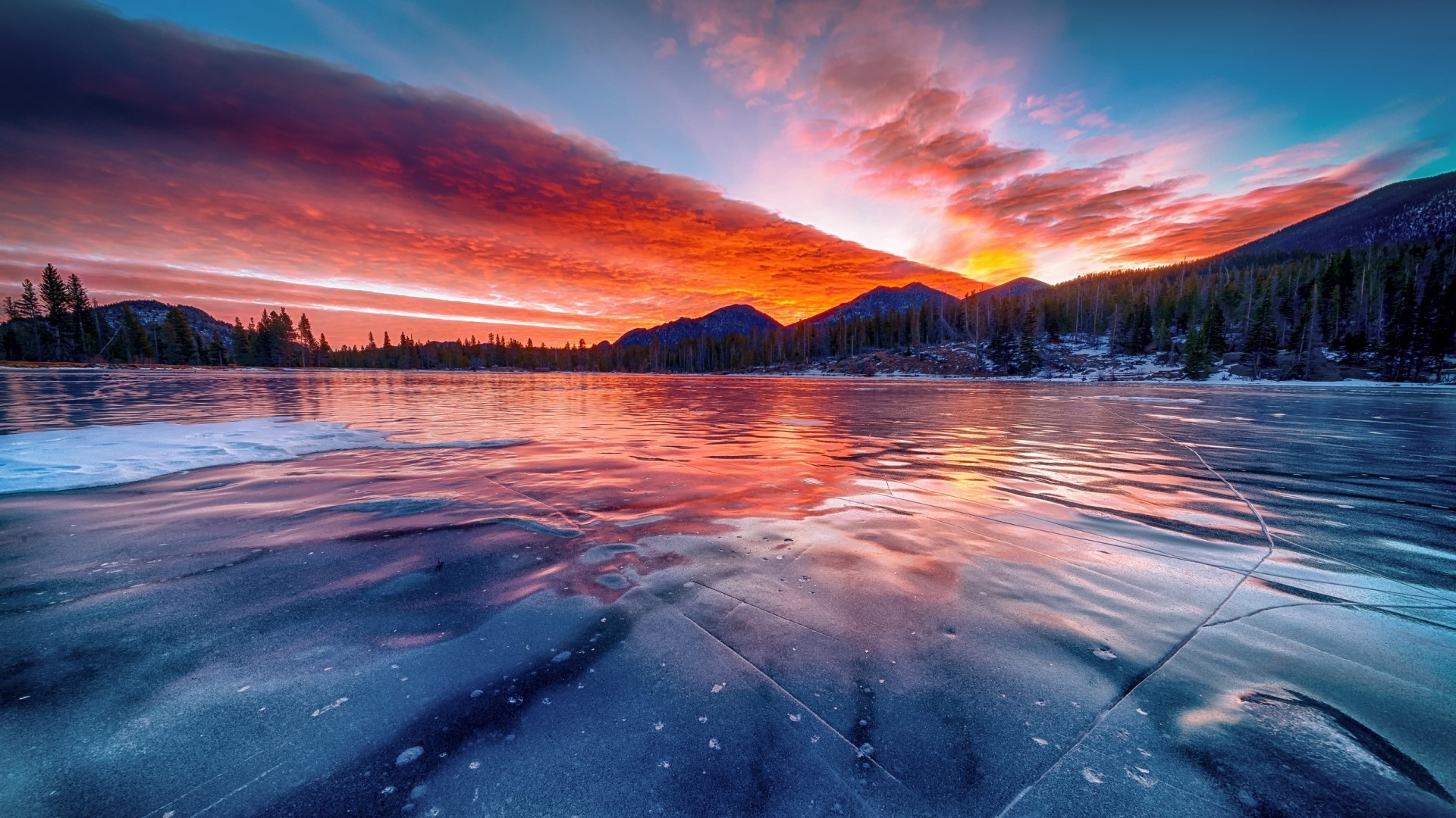 Sunrise over a frozen lake with mountains HD Wallpaper