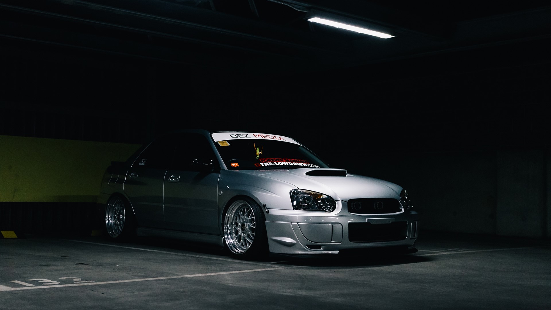 Silver Subaru Impreza in a dimly lit parking garage HD Wallpaper
