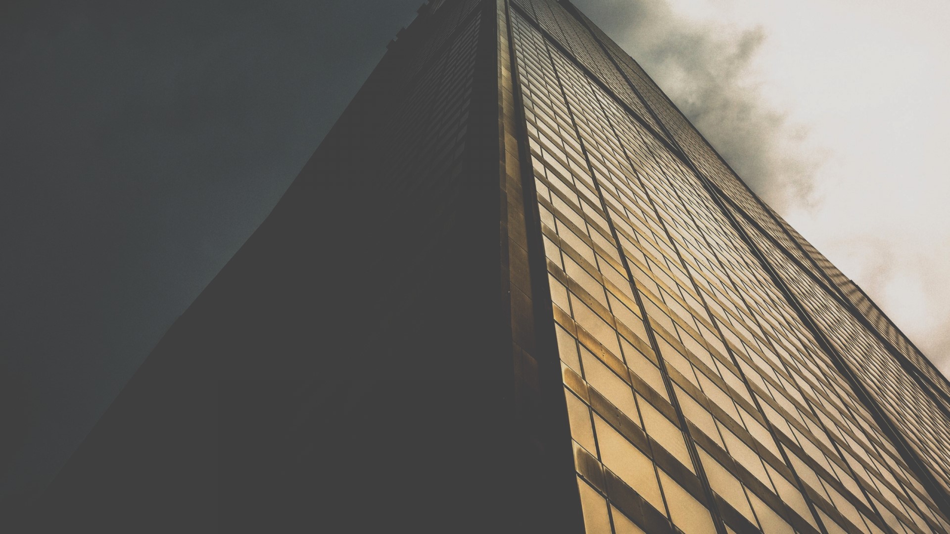 Skyscraper with glass facade against cloudy sky HD Wallpaper