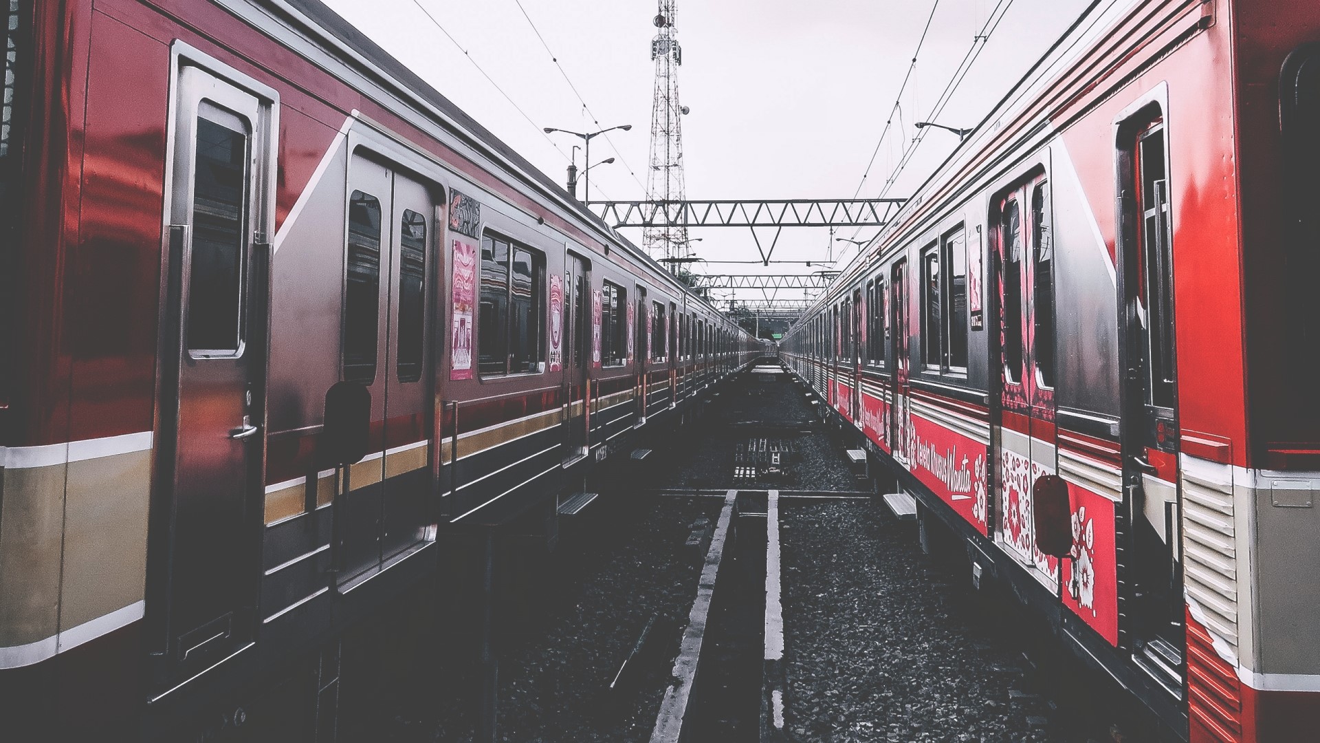 Two red trains on parallel tracks HD Wallpaper