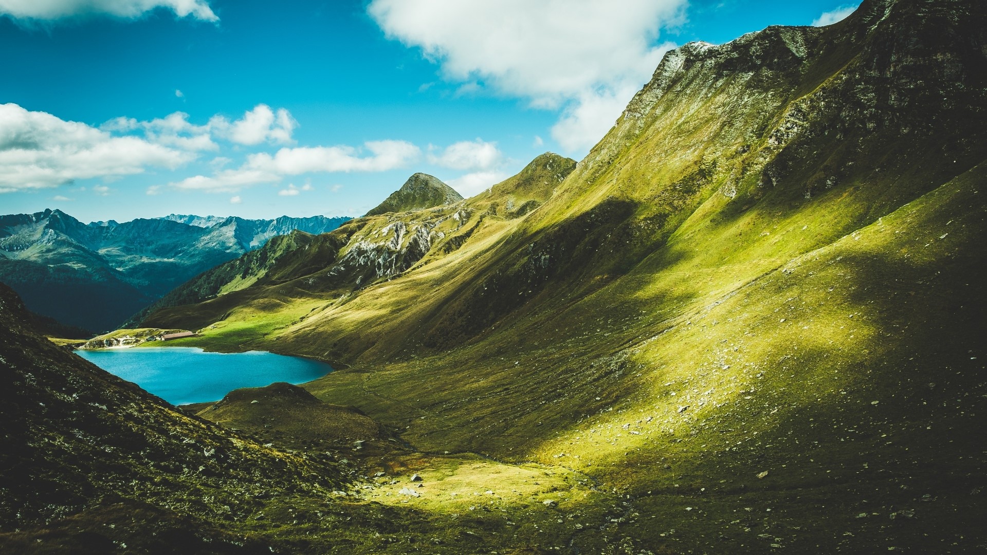 Mountain lake with green slopes and blue sky HD Wallpaper
