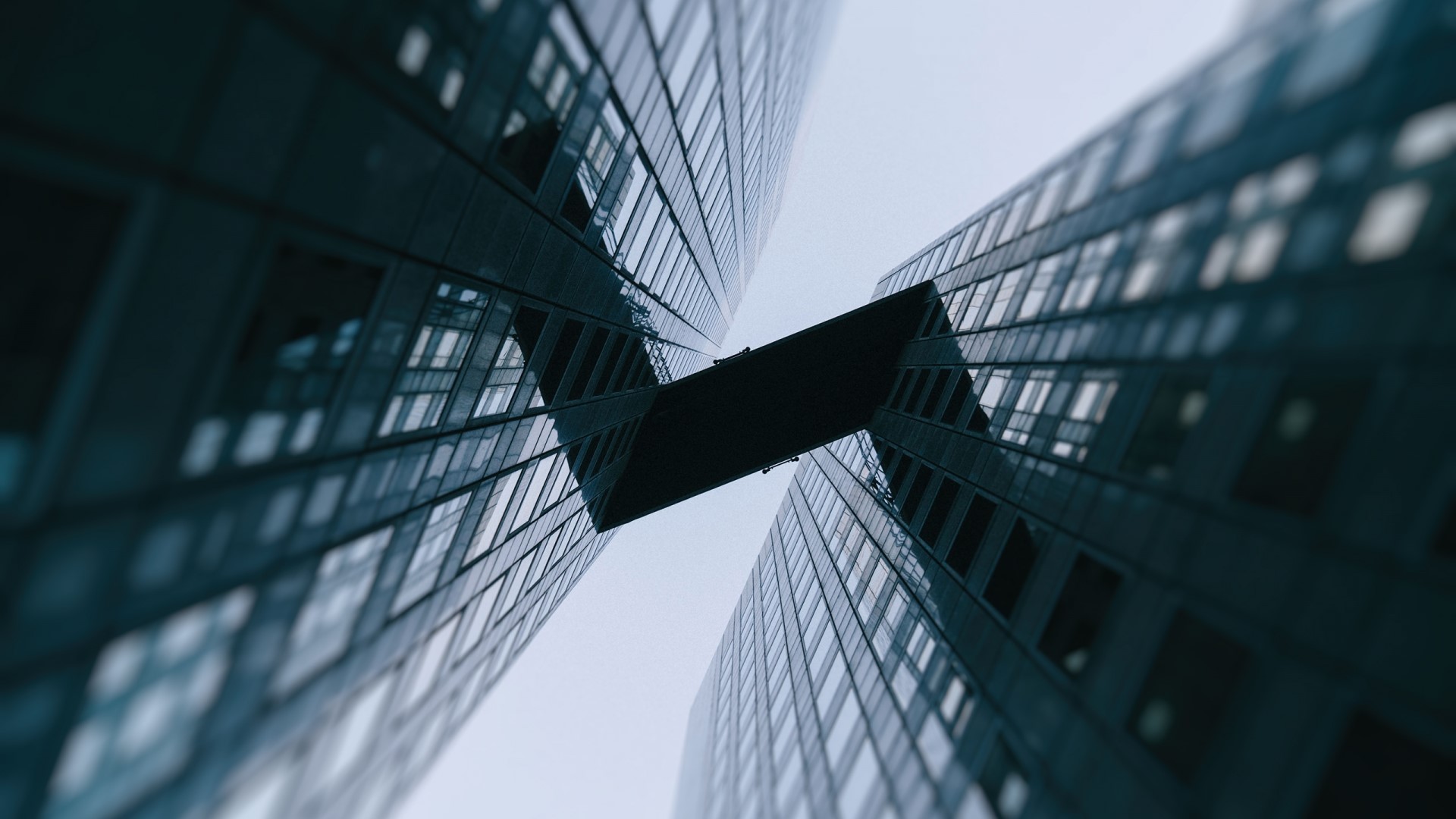 Two modern skyscrapers connected by a skybridge HD Wallpaper
