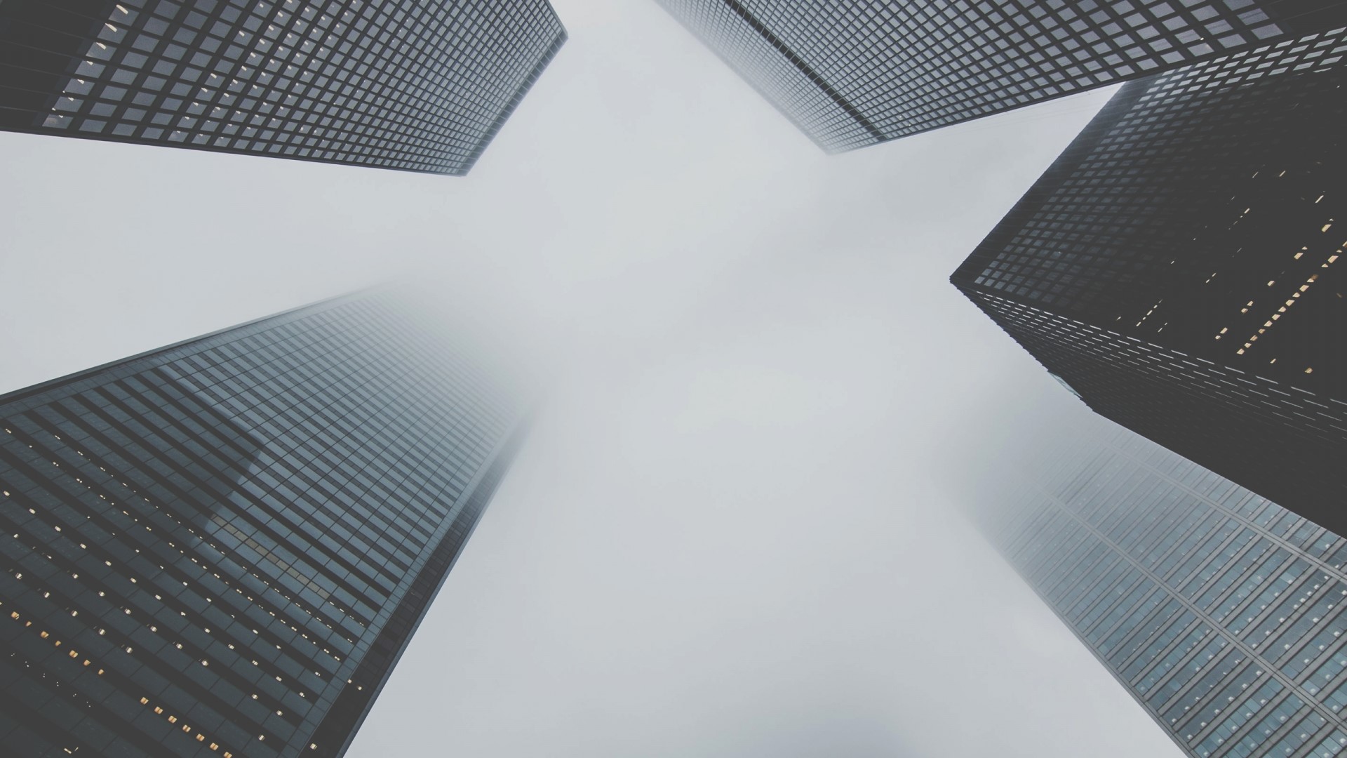 Skyscrapers shrouded in fog HD Wallpaper