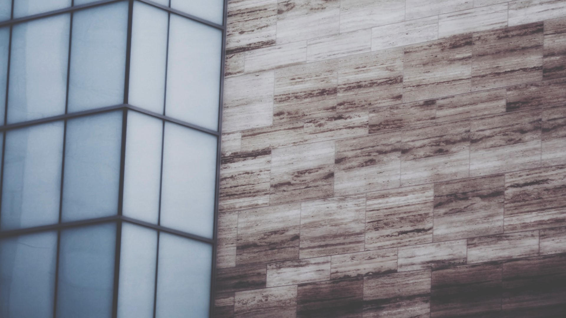 Modern building facade with glass windows and stone cladding HD Wallpaper