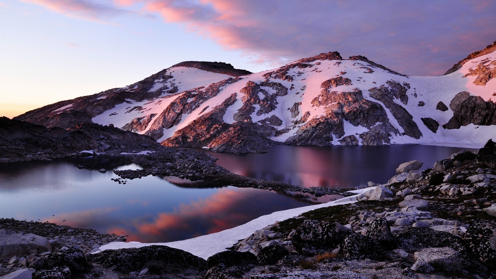 Snow-capped mountains reflected in a lake at sunset HD Wallpaper