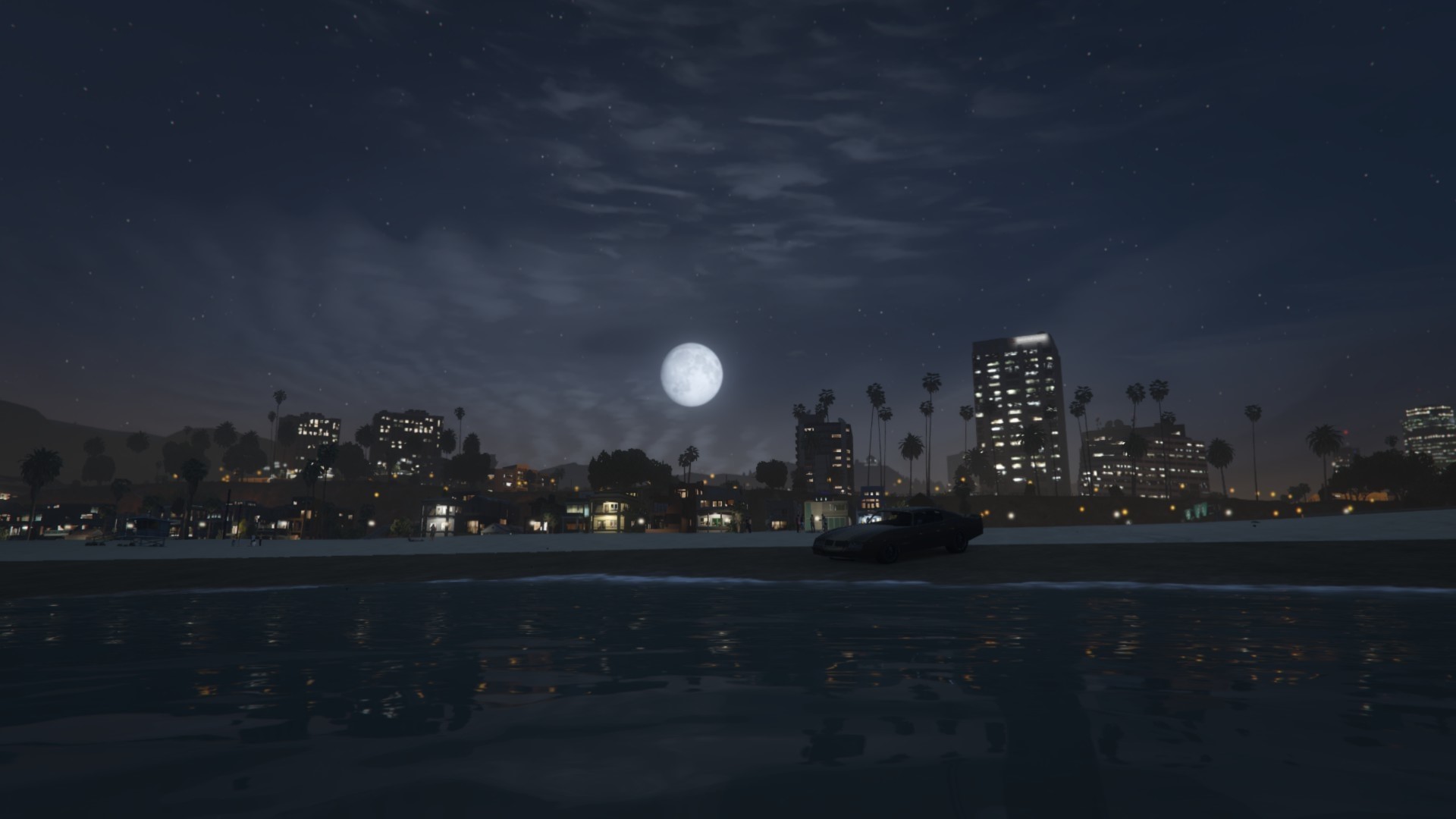 Nighttime cityscape with moon over beach and ocean HD Wallpaper