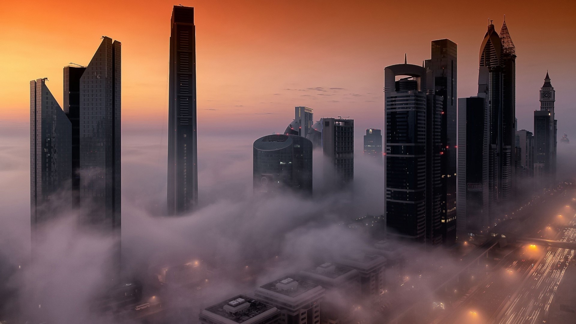 Dubai skyscrapers emerge from fog at sunrise HD Wallpaper
