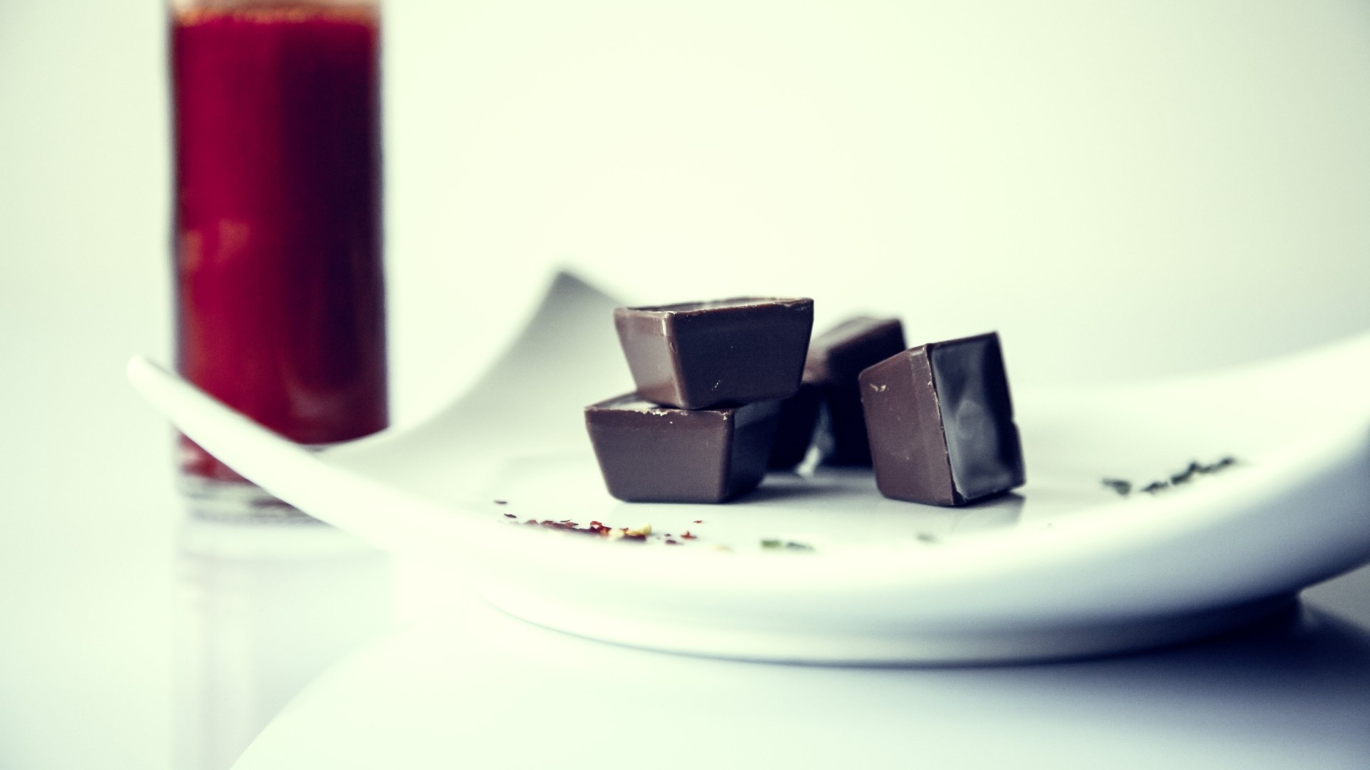 Chocolate candies and a glass of red juice HD Wallpaper
