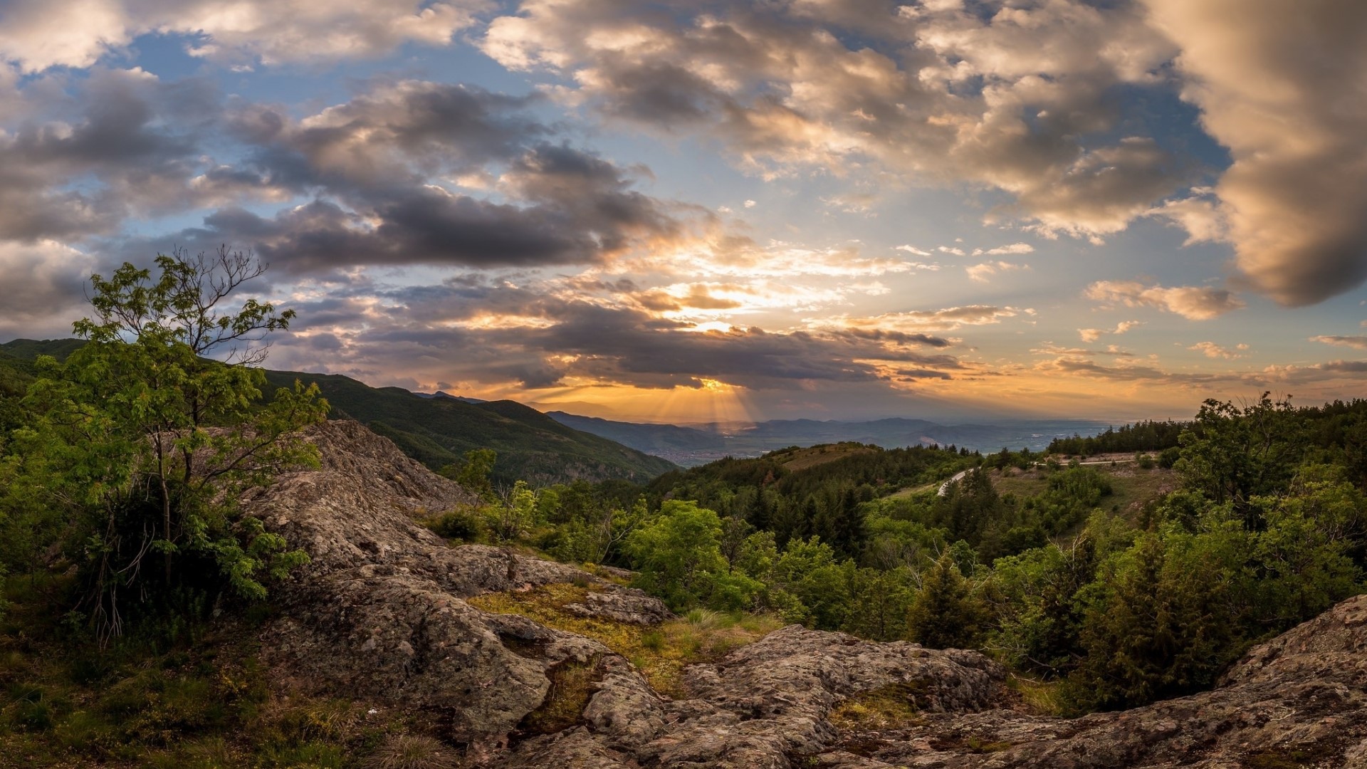 Sunset over a mountainous valley with clouds HD Wallpaper