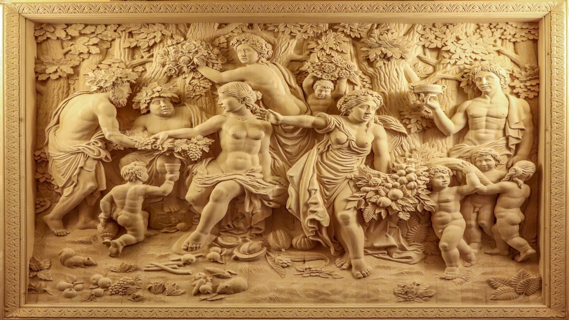 Wood carving of a mythological scene with figures and cherubs HD Wallpaper