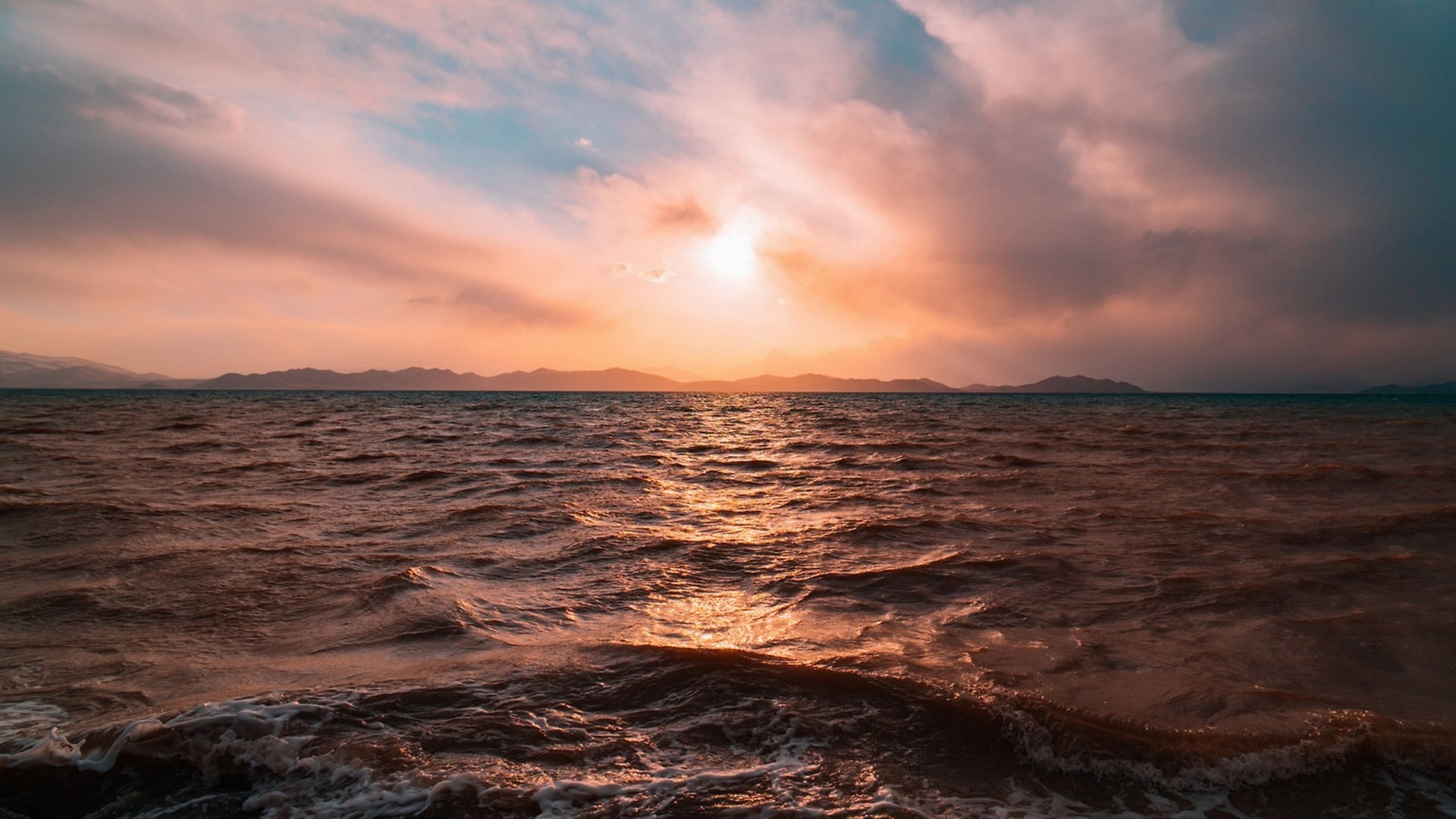 Sunset over the sea with mountains HD Wallpaper