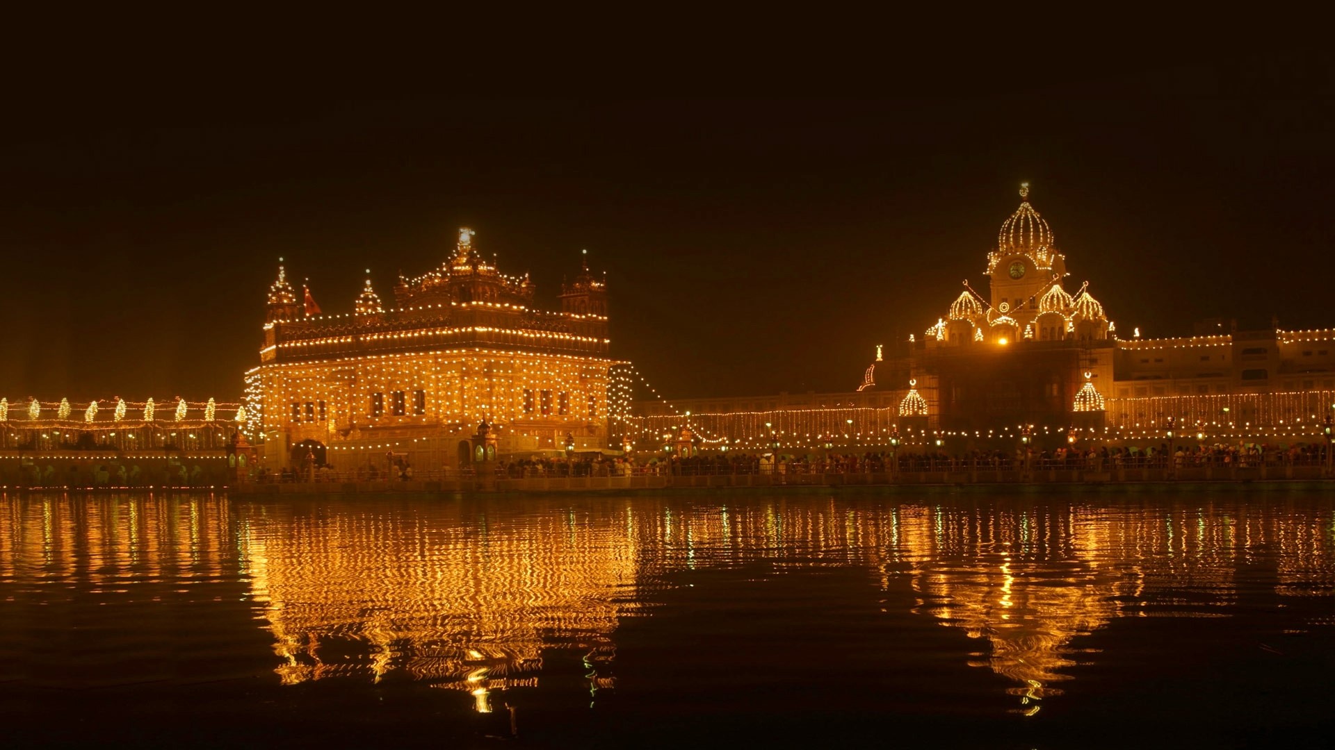 Golden Temple illuminated at night HD Wallpaper
