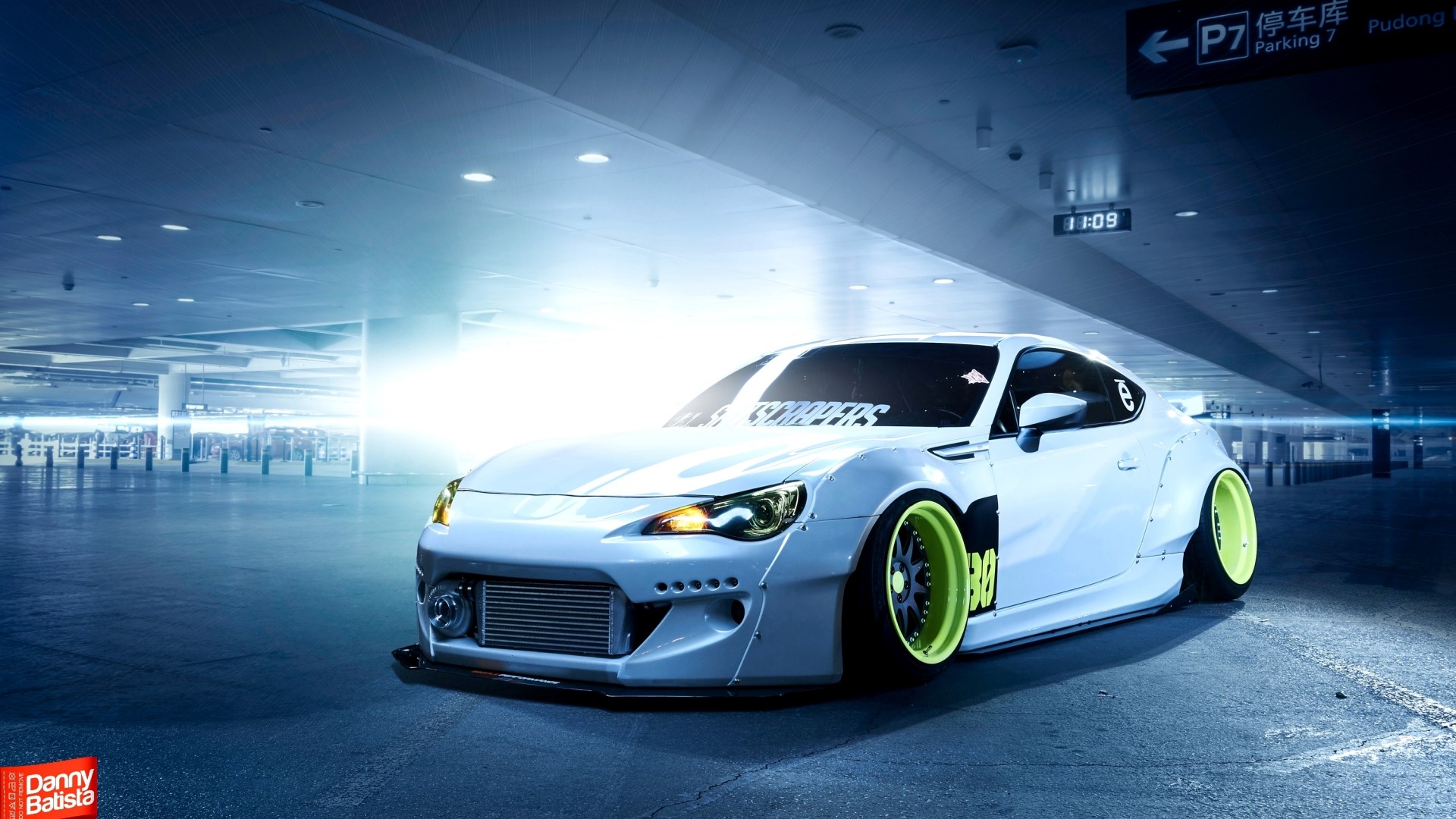 White Subaru BRZ with neon green rims in parking garage HD Wallpaper