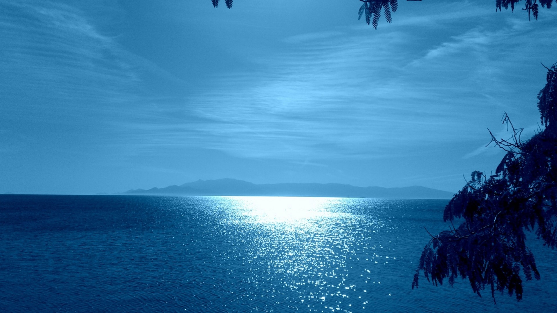 Sunlight on the Sea with Distant Mountains HD Wallpaper